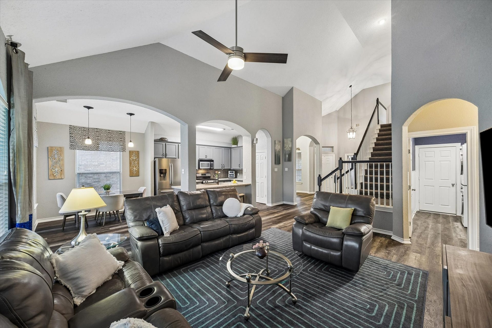 5115 Redleaf Forest Lane, Katy, TX 77494 Soaring vaulted ceilings create an impressive sense of openness and grandeur in the family room, enhancing the home's spacious feel while allowing natural light to beautifully illuminate the space.