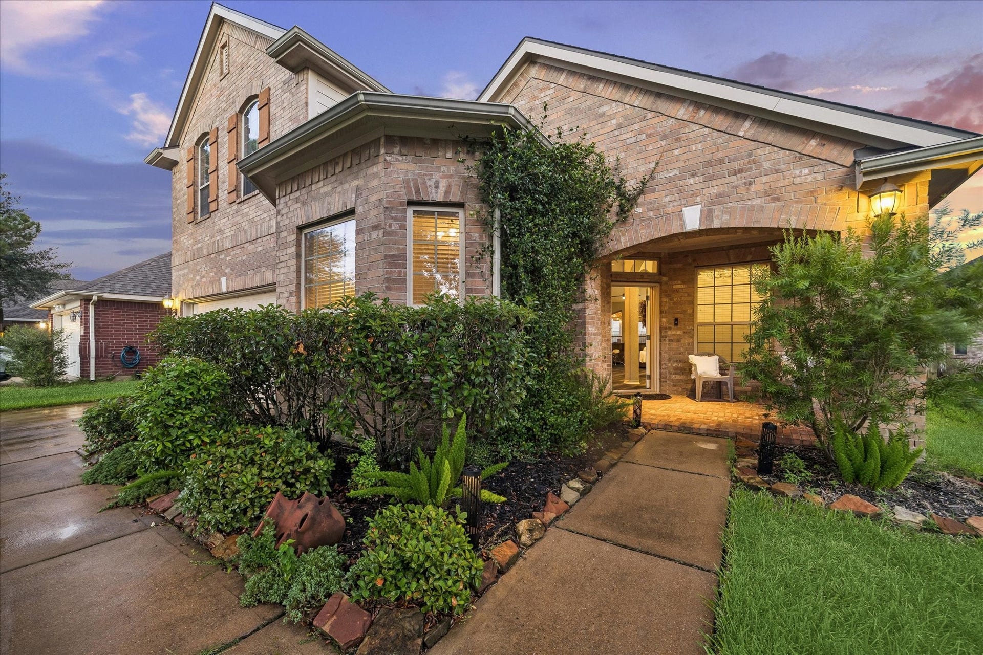 5115 Redleaf Forest Lane, Katy, TX 77494 Lush, beautifully maintained landscaping surrounds the inviting front porch, creating a warm and welcoming first impression as you approach the home. Mature greenery and thoughtfully designed garden beds add charm and curb appeal, setting the tone for what awaits inside.