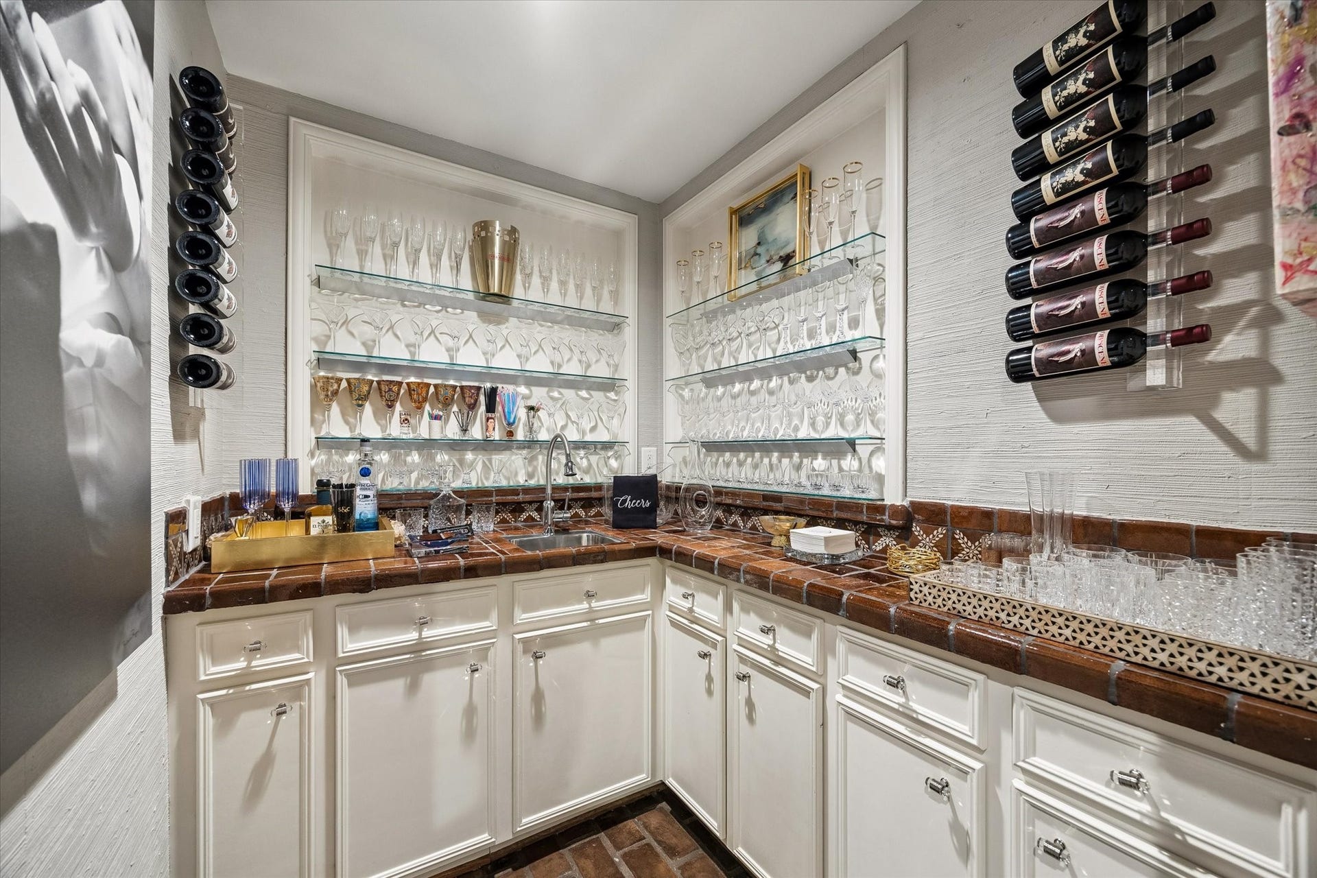 How about a cocktail or mocktail before we begin our tour? Refreshed cabinetry with a Saltillo tile counter and brick floors warm the Wet Bar.  If you are more for an open feel...feel free to open up the two casements and connect the Wet Bar to the Great Room and the Den.