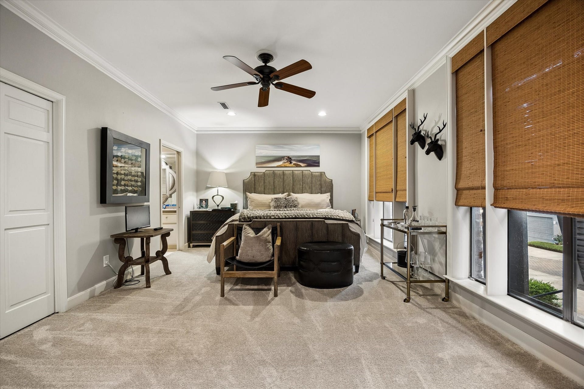Guest Suite 2 features recent carpet, crown moulding, matchstick blinds and ample closet space.