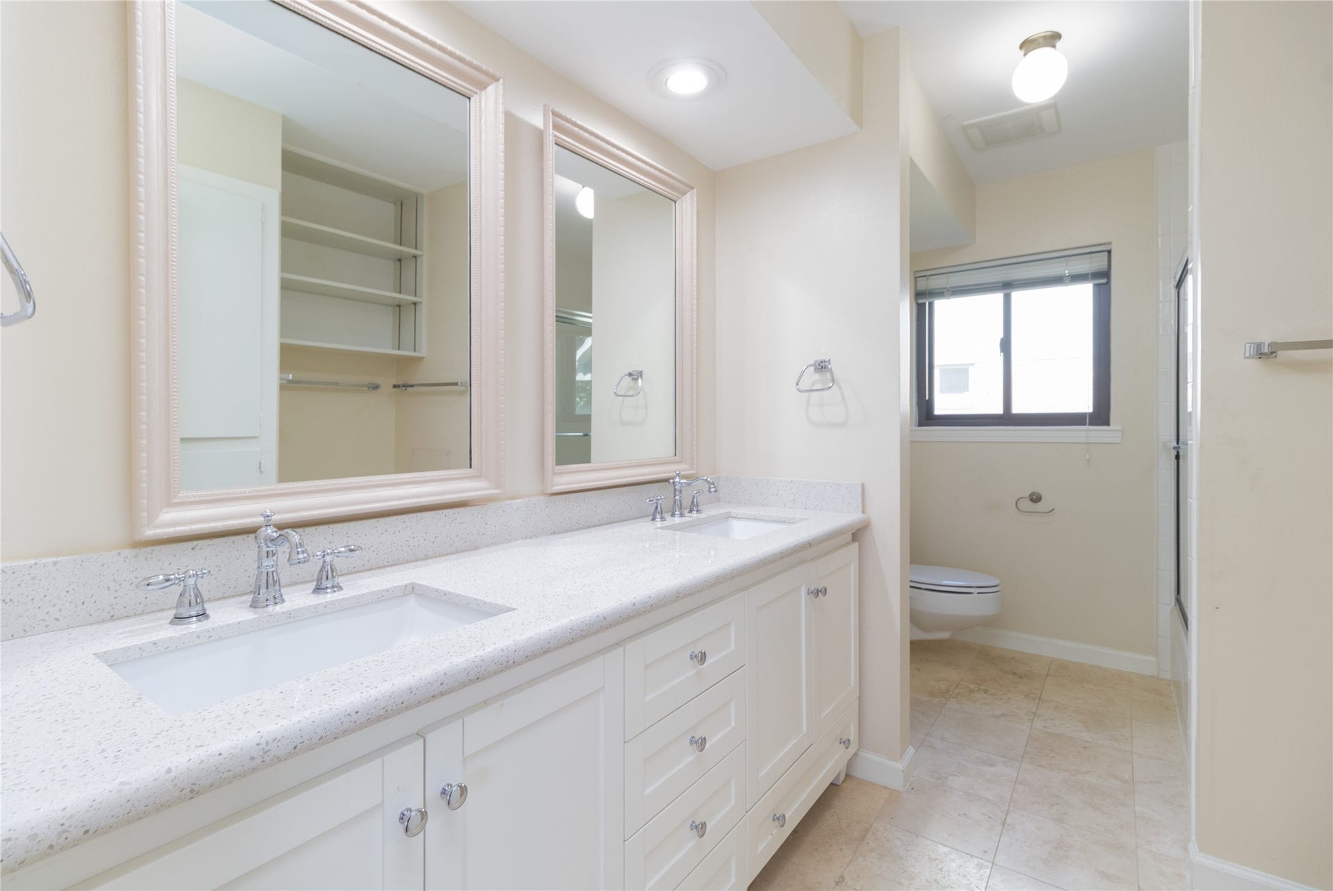8919 Manhattan Drive, Houston, TX 77096 Secondary bath features a long dual-sink vanity and generous cabinetry.