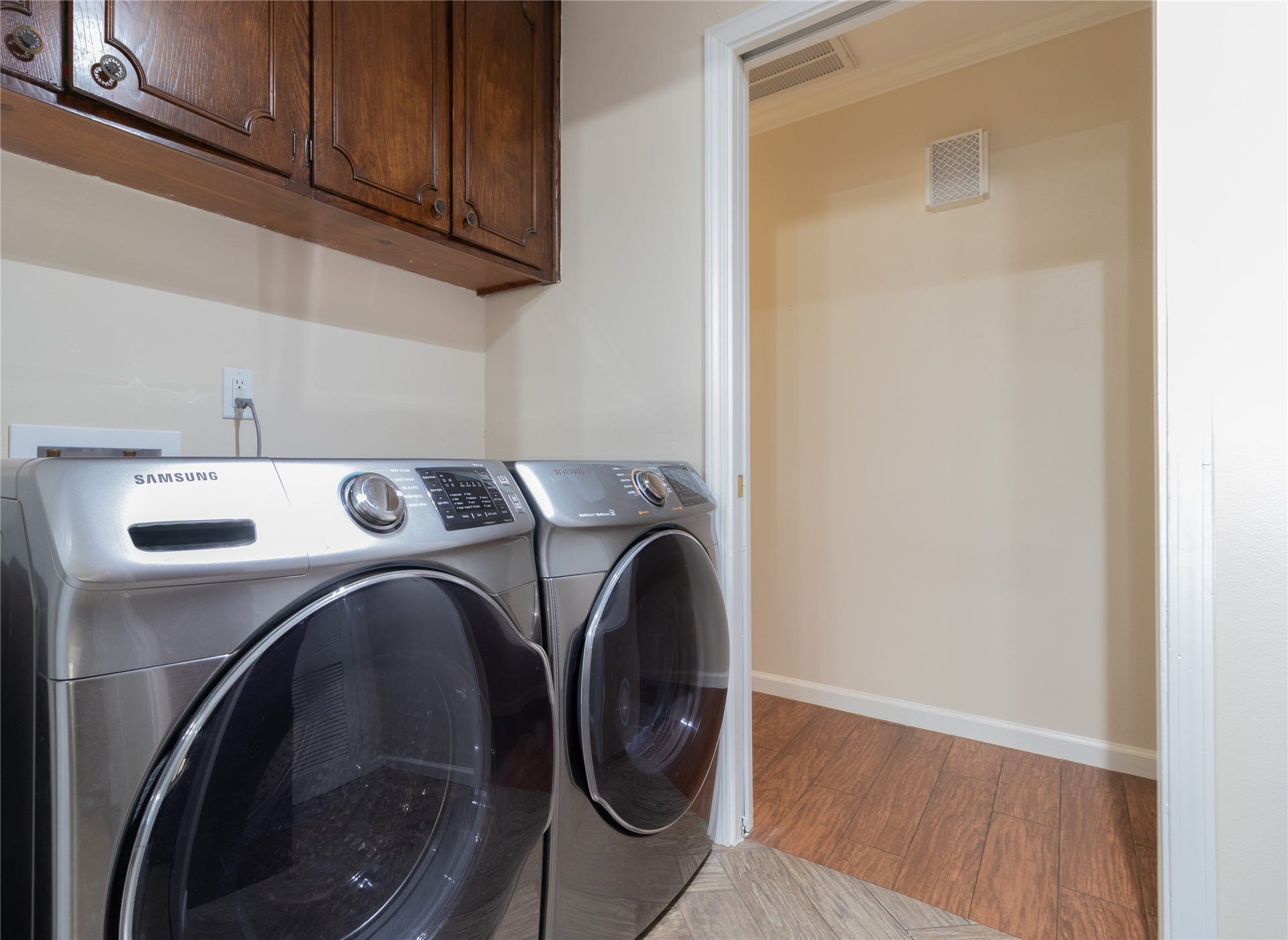 8919 Manhattan Drive, Houston, TX 77096 Indoor utility room with full-size laundry connections and adjacent storage.