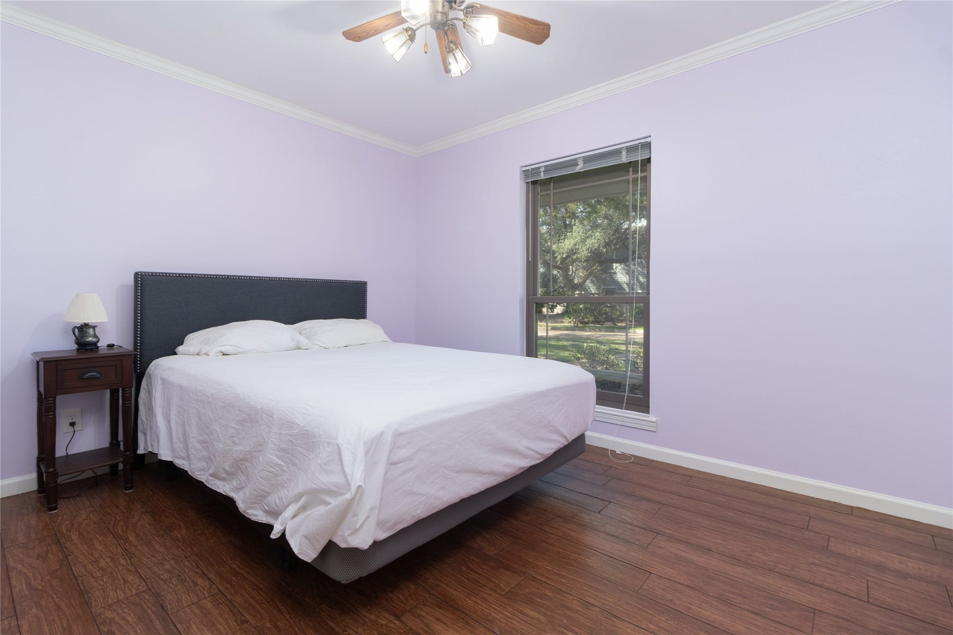8919 Manhattan Drive, Houston, TX 77096 Secondary bedroom offers wood-look flooring, crown molding and natural light.