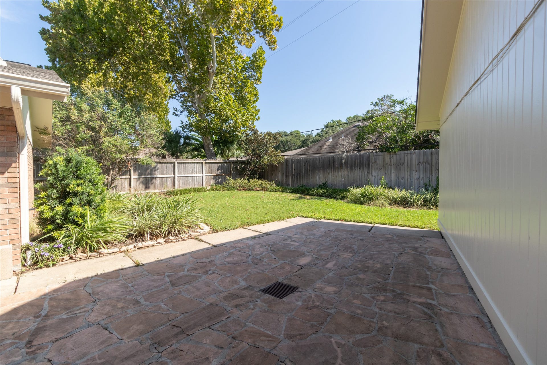 8919 Manhattan Drive, Houston, TX 77096 Stone patio creates an additional outdoor gathering and entertaining area