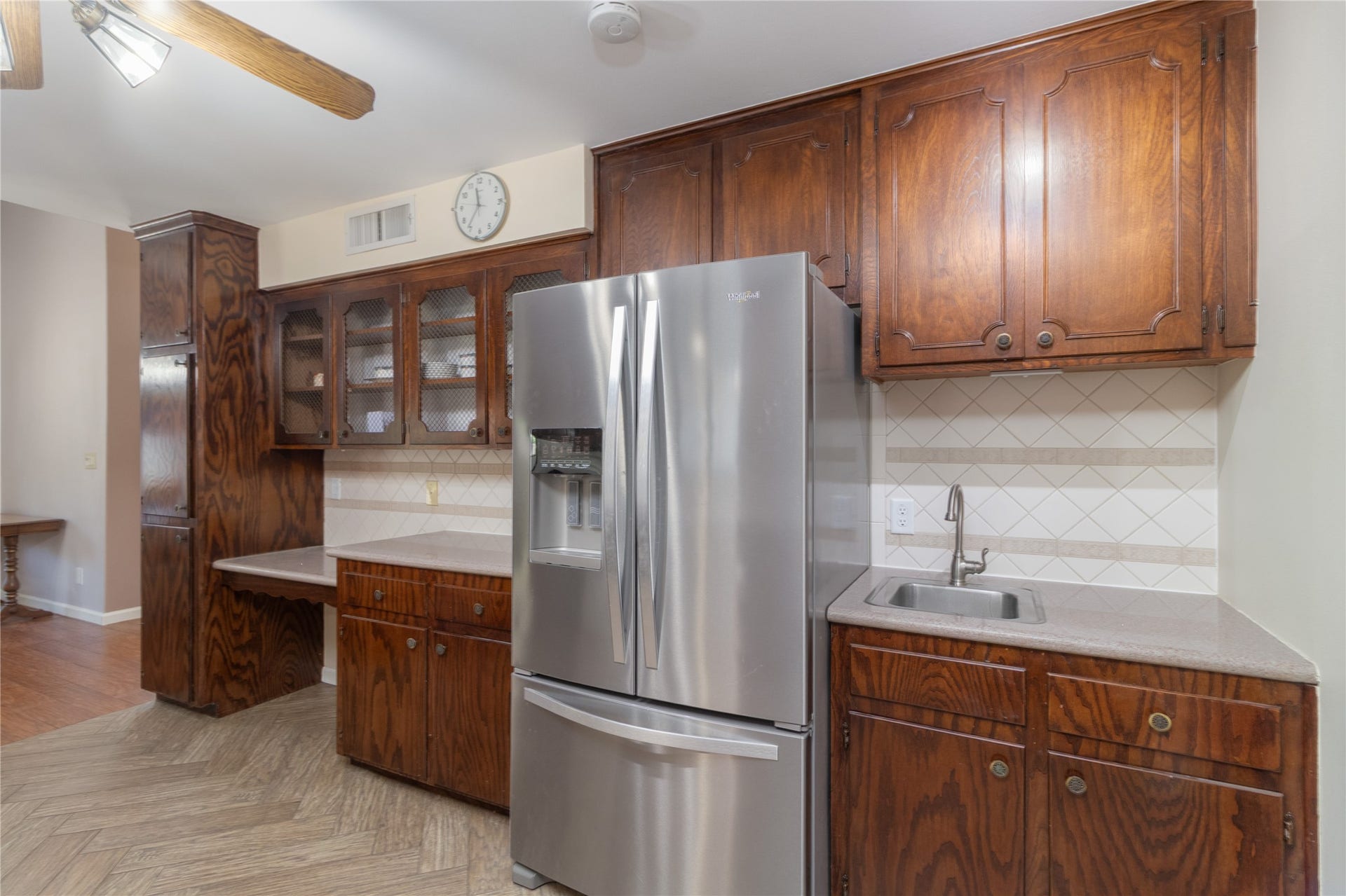8919 Manhattan Drive, Houston, TX 77096 Additional cabinetry, stainless refrigerator and counter space offer plenty of kitchen storage and prep area.