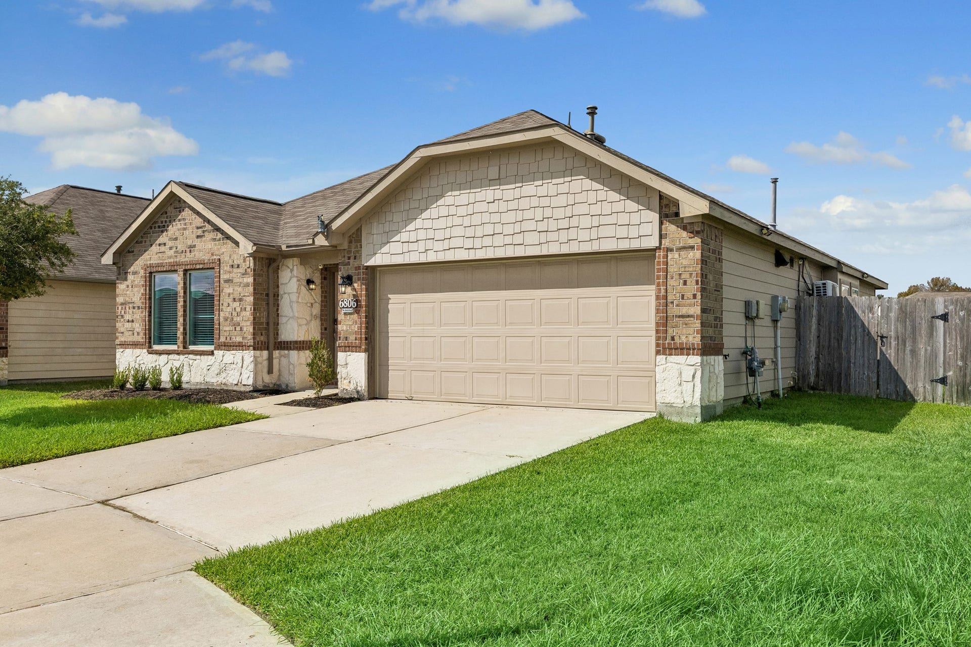 Beautiful brick and stone exterior with shake garage accents enhances the curb appeal on this cul de sac lot