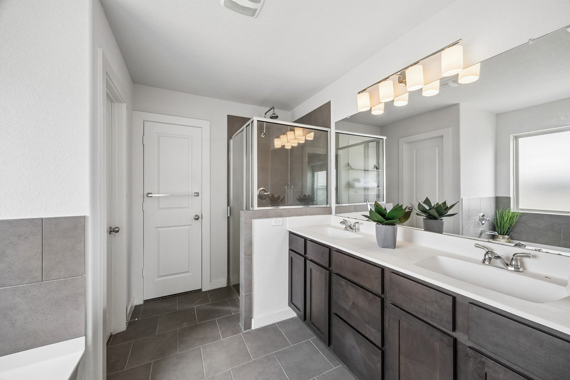 Dual sink, walk in shower, soaking tub, wet room, and large walk in closet adorn the primary bedroom set and bath.