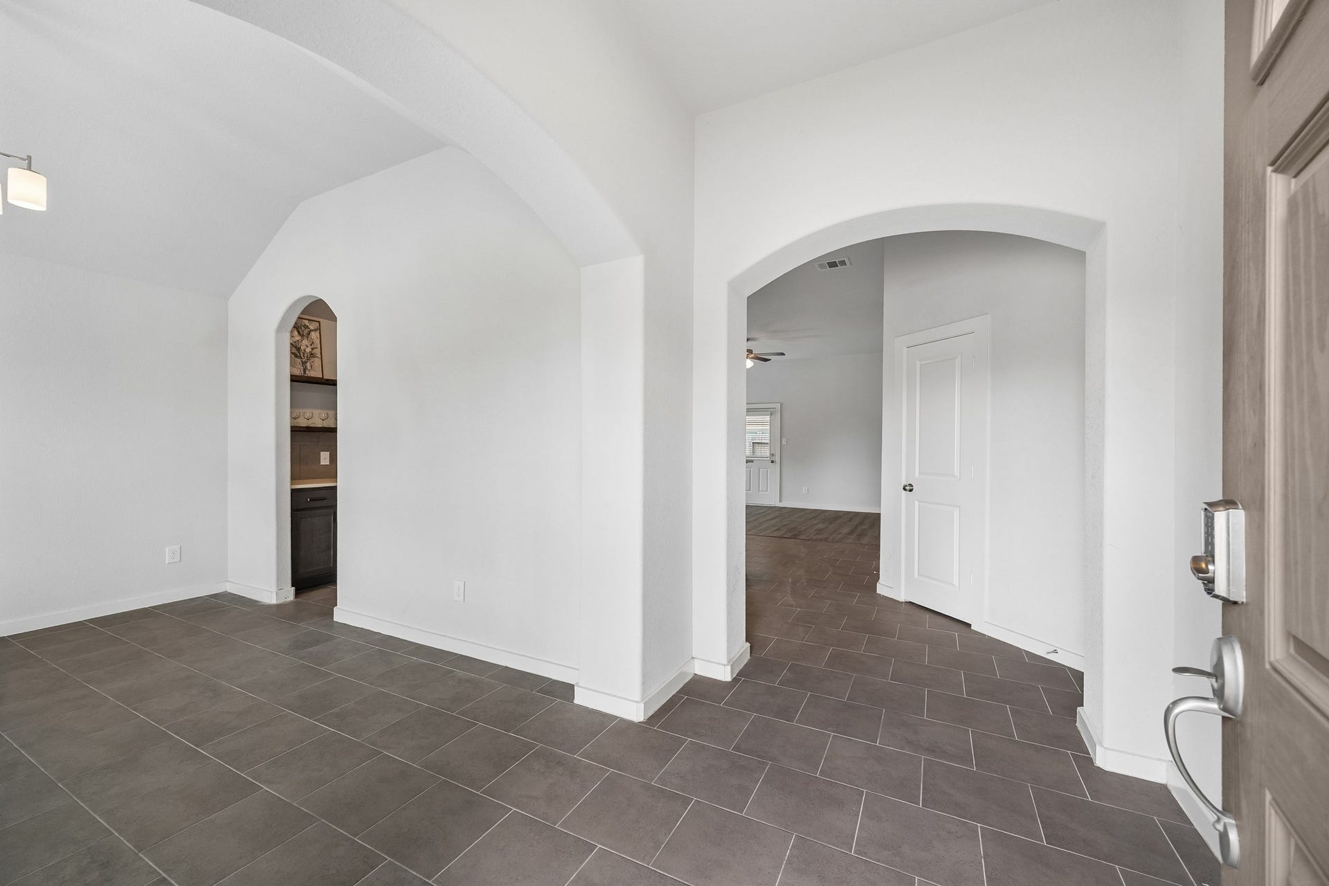Beautiful arched doorways upon entry into the home office/dining flex space.