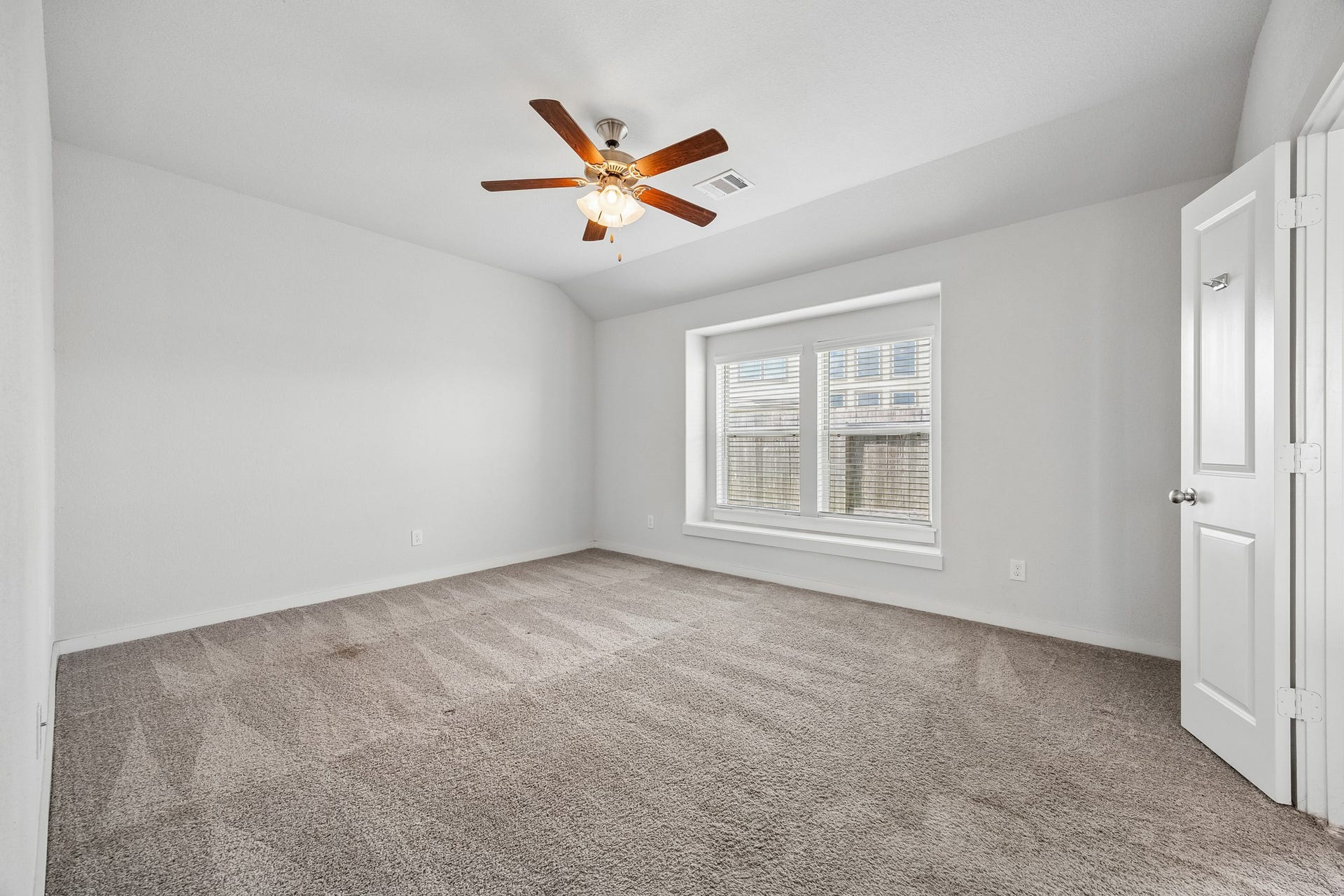 Neutral carpet, ceiling fan, large windows, big space and en-suite bath create the perfect owners retreat.