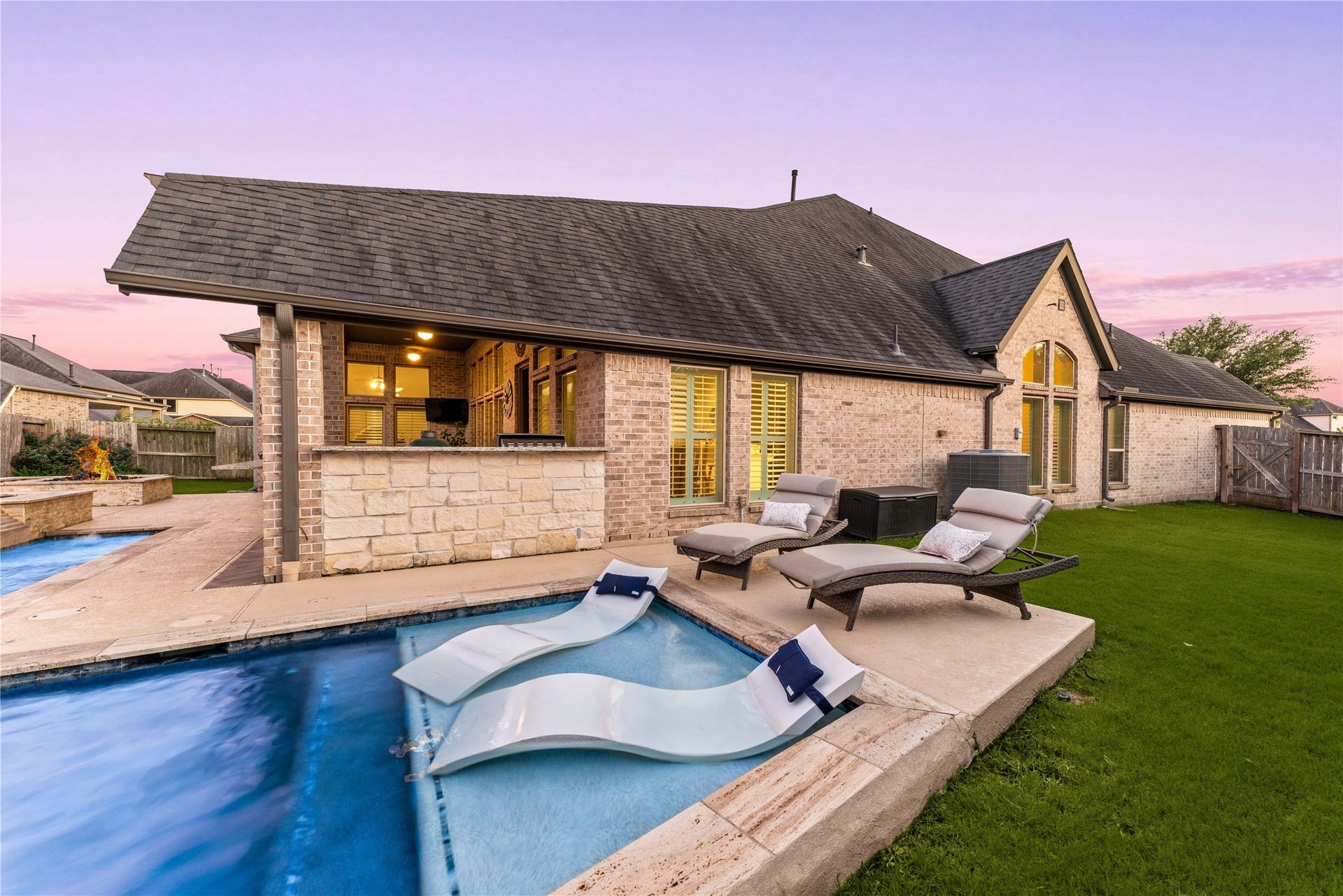 4103 August Light Court, Fulshear, TX 77441 Soak up the sun or lounge under evening stars on this premium tanning ledge and poolside sun deck.A sparkling in-ground pool features a dedicated, shallow baja shelf perfect for some in-water loungers for the ultimate resort experience. Sprawling stone pavers wrap the pool edge, transitioning into a wide concrete deck that offers plenty of space for open-air seating.