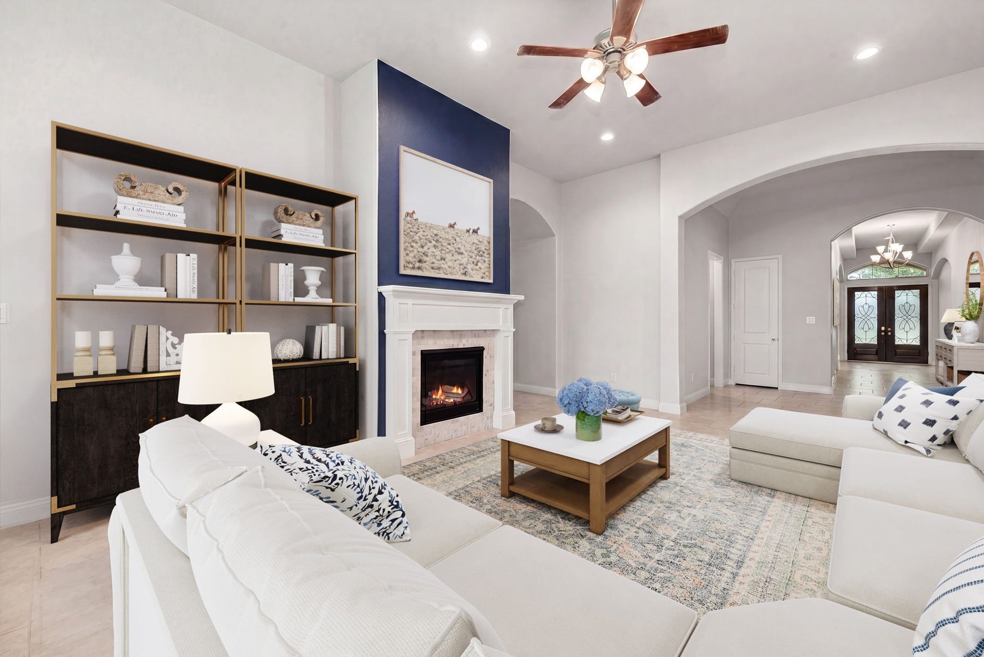 4103 August Light Court, Fulshear, TX 77441 An elegant, modern fireplace serves as the dramatic focal point of the room. Architecturally striking arched doorways frame the transitions between spaces, adding a touch of classic charm and depth to the bright, open layout. *Virtually Staged