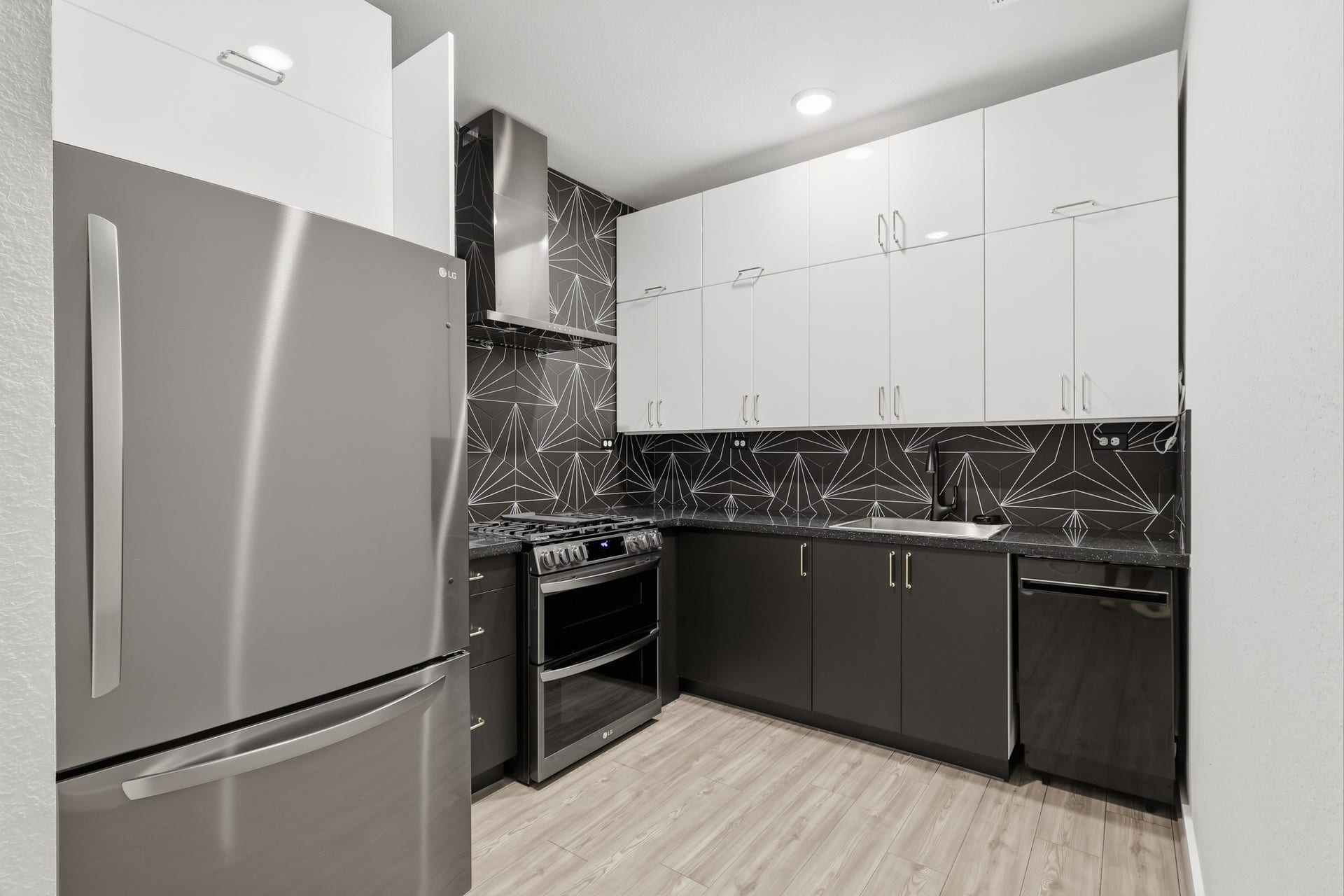 31539 Beacon Cove Trail, Fulshear, TX 77441 This stunning property features a complete second kitchen equipped with a refrigerator, dishwasher, sink, premium cooking appliances, and custom cabinetry.