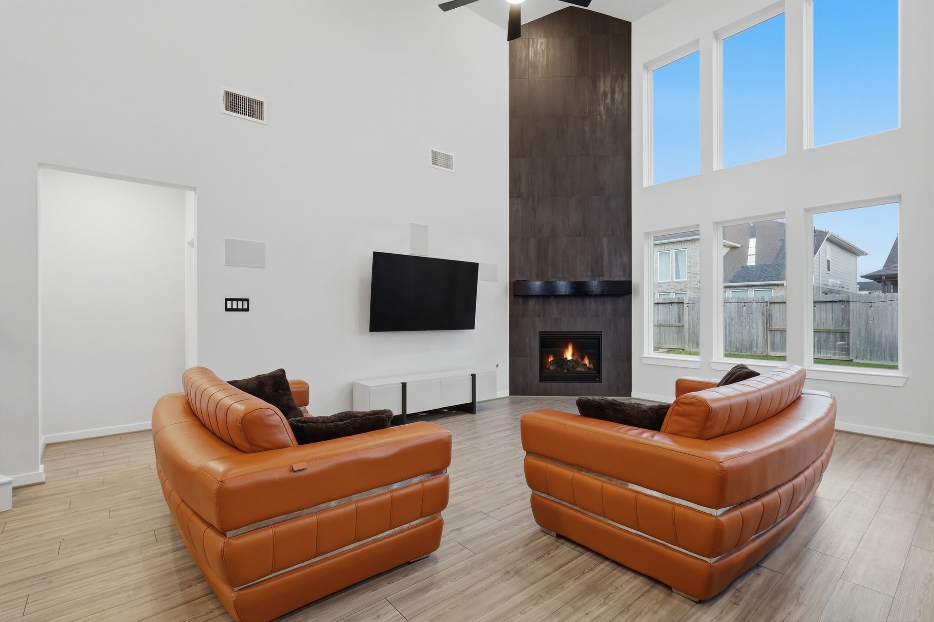 31539 Beacon Cove Trail, Fulshear, TX 77441 The floor-to-ceiling fireplace anchors the room with bold contrast and a contemporary edge.
