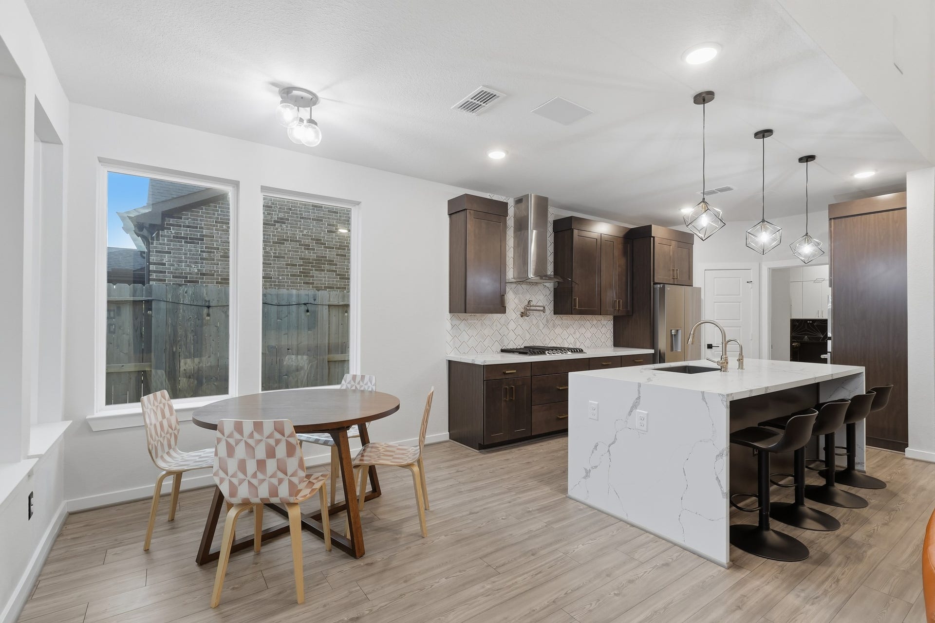 31539 Beacon Cove Trail, Fulshear, TX 77441 Breakfast area with seamless flow between kitchen and covered patio, ideal for casual dining and indoor-outdoor living.