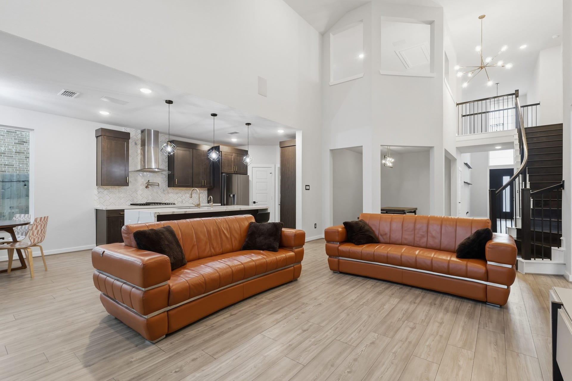 31539 Beacon Cove Trail, Fulshear, TX 77441 Open-concept layout featuring seamless sightlines between the family room, kitchen, and dining areas.