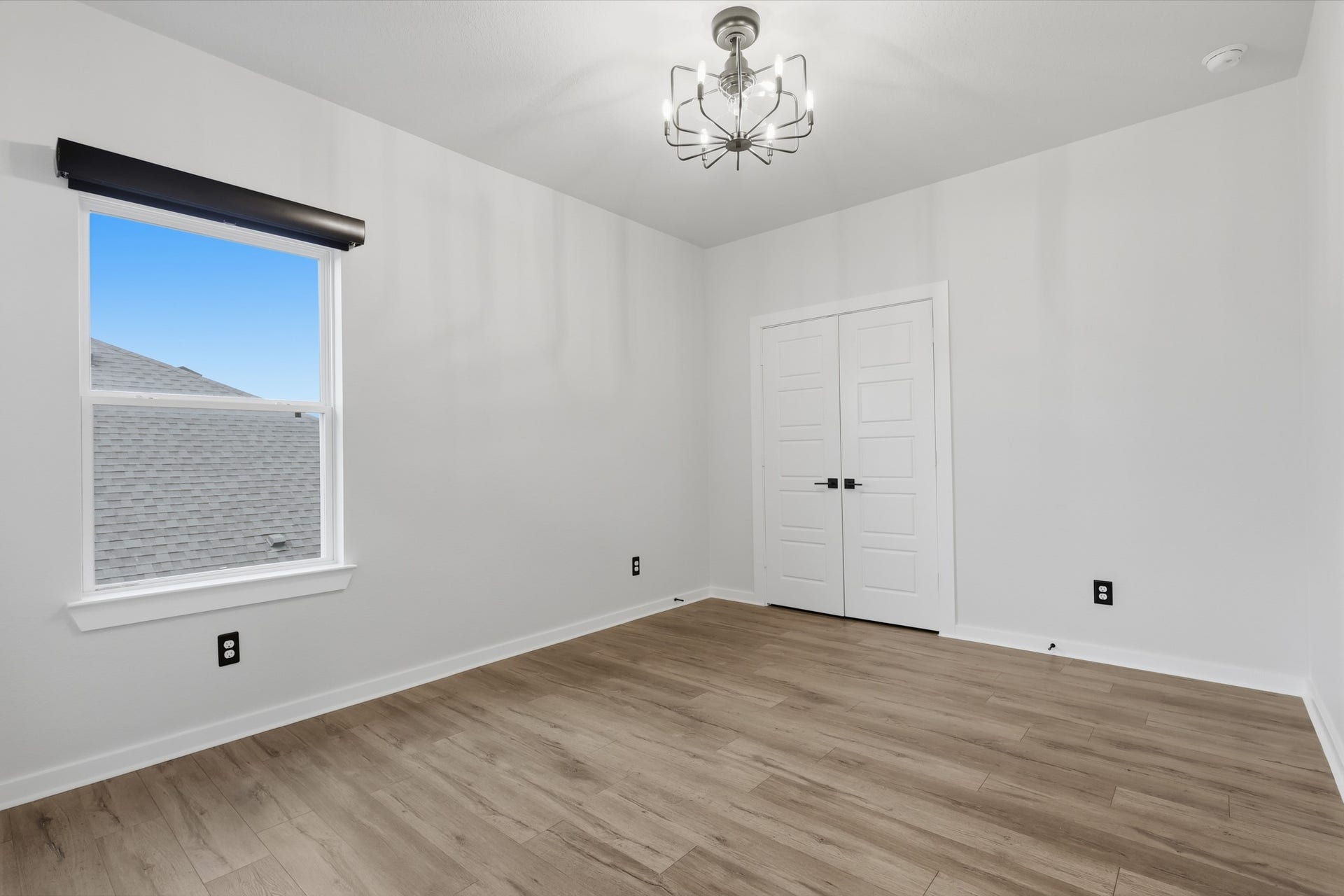 31539 Beacon Cove Trail, Fulshear, TX 77441 Bedroom 3 offers a bright neutral setting with a contemporary light fixture and private closet.