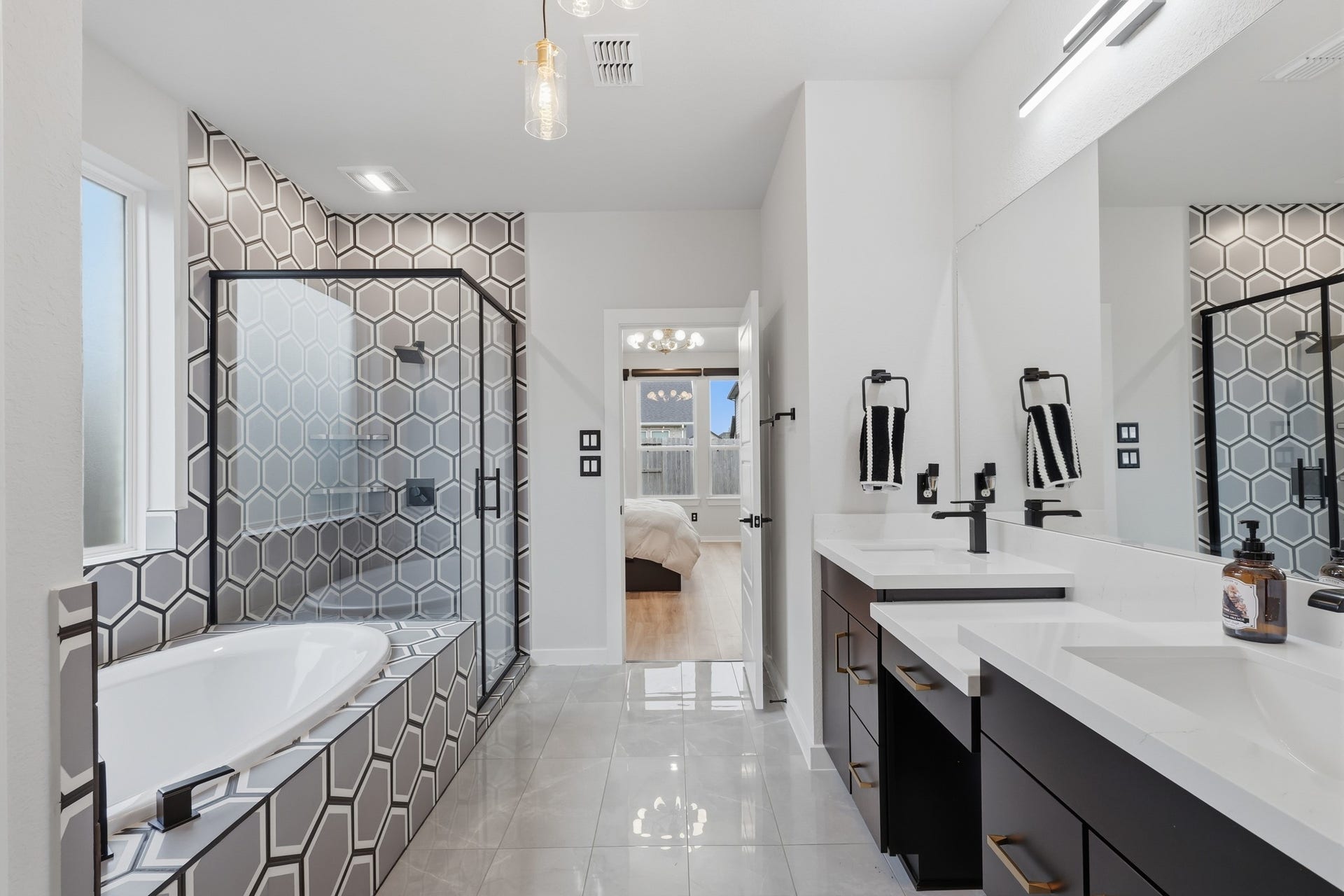 31539 Beacon Cove Trail, Fulshear, TX 77441 The primary bath pairs a soaking tub and separate shower with dual vanities and elevated countertops.