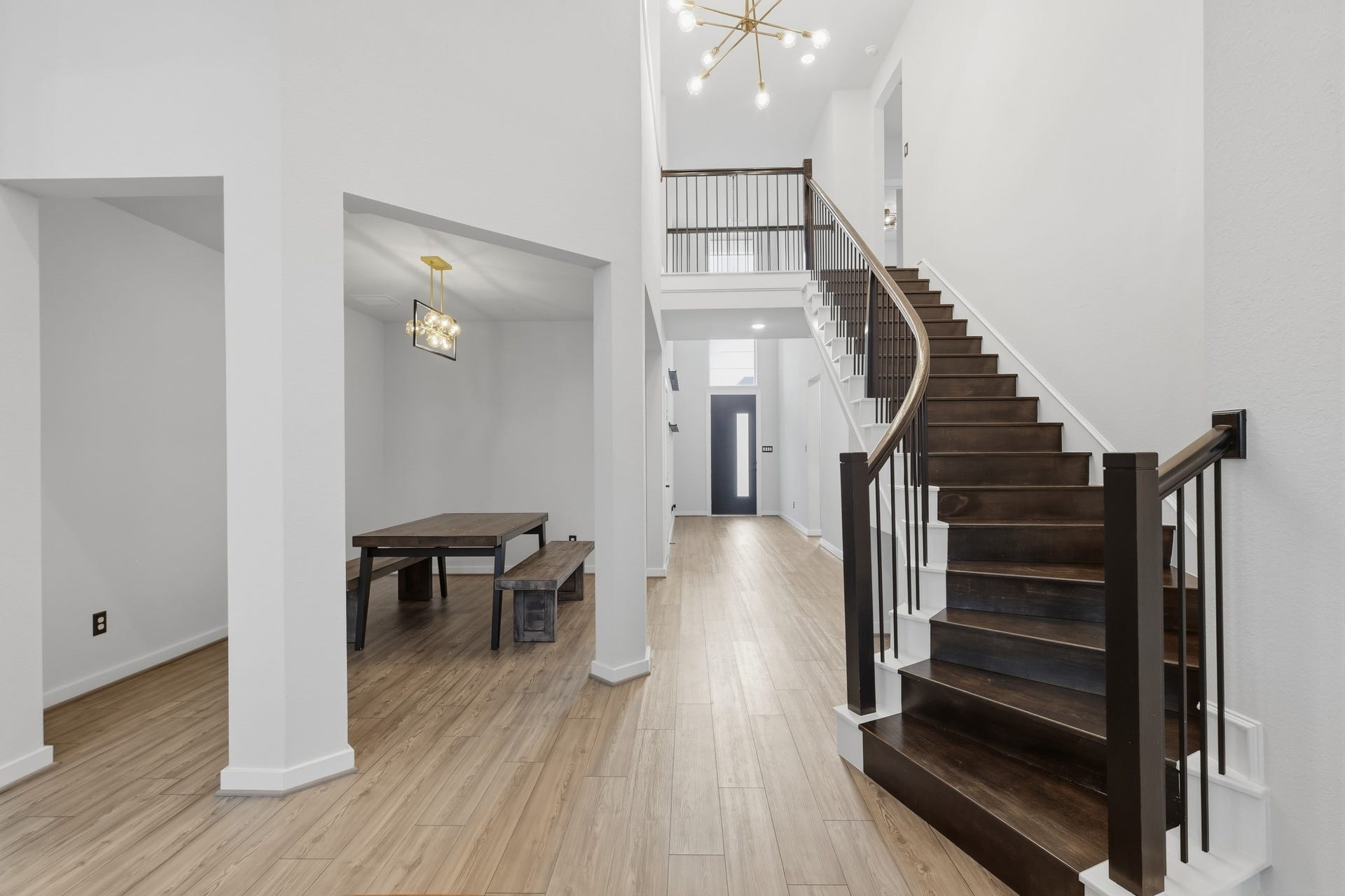 31539 Beacon Cove Trail, Fulshear, TX 77441 Grand curved staircase connecting the two levels.