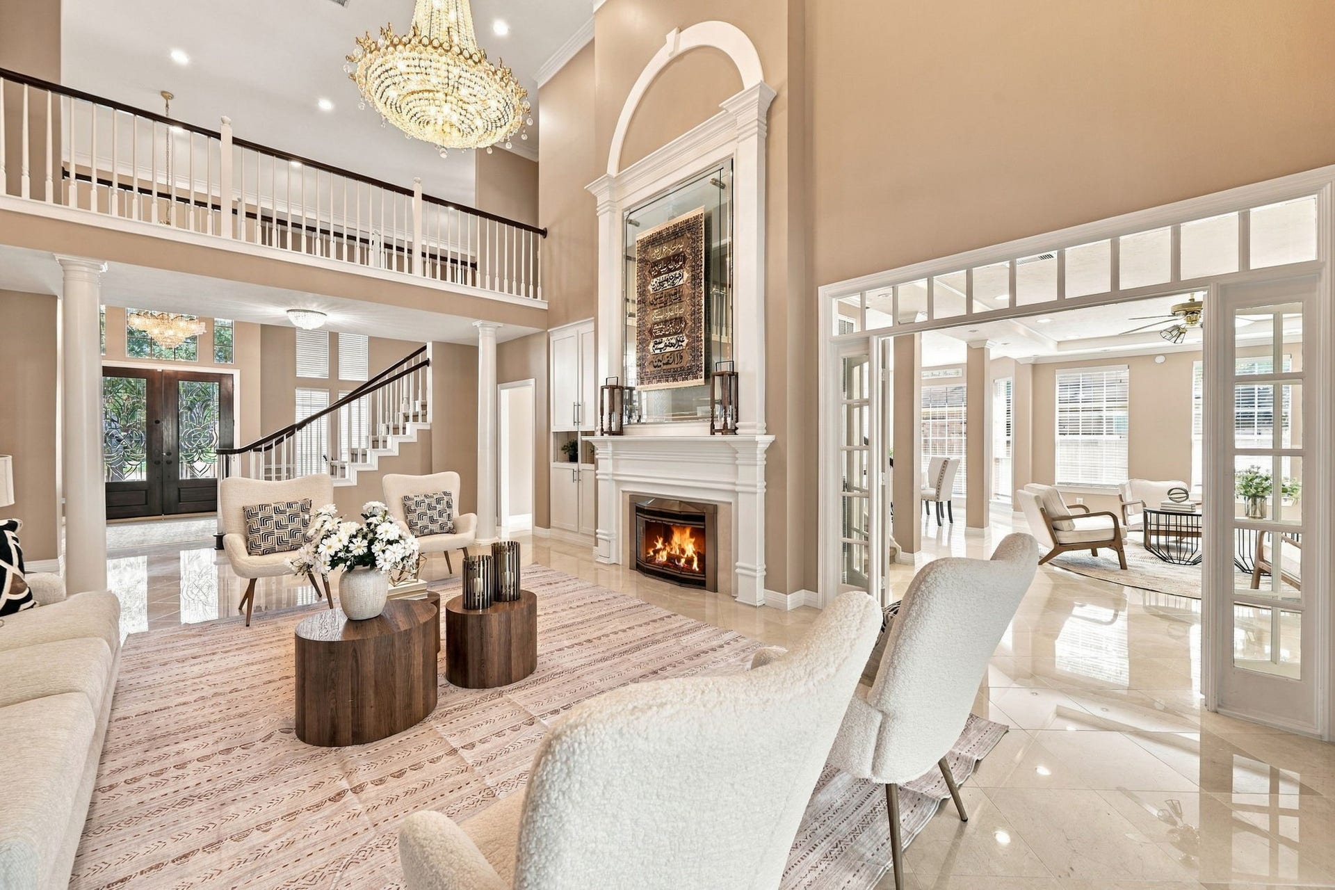 7610 Northwoods Drive, Sugar Land, TX 77479 The living room makes a lasting impression with its architectural detailing, fireplace, and open sightlines across the home.