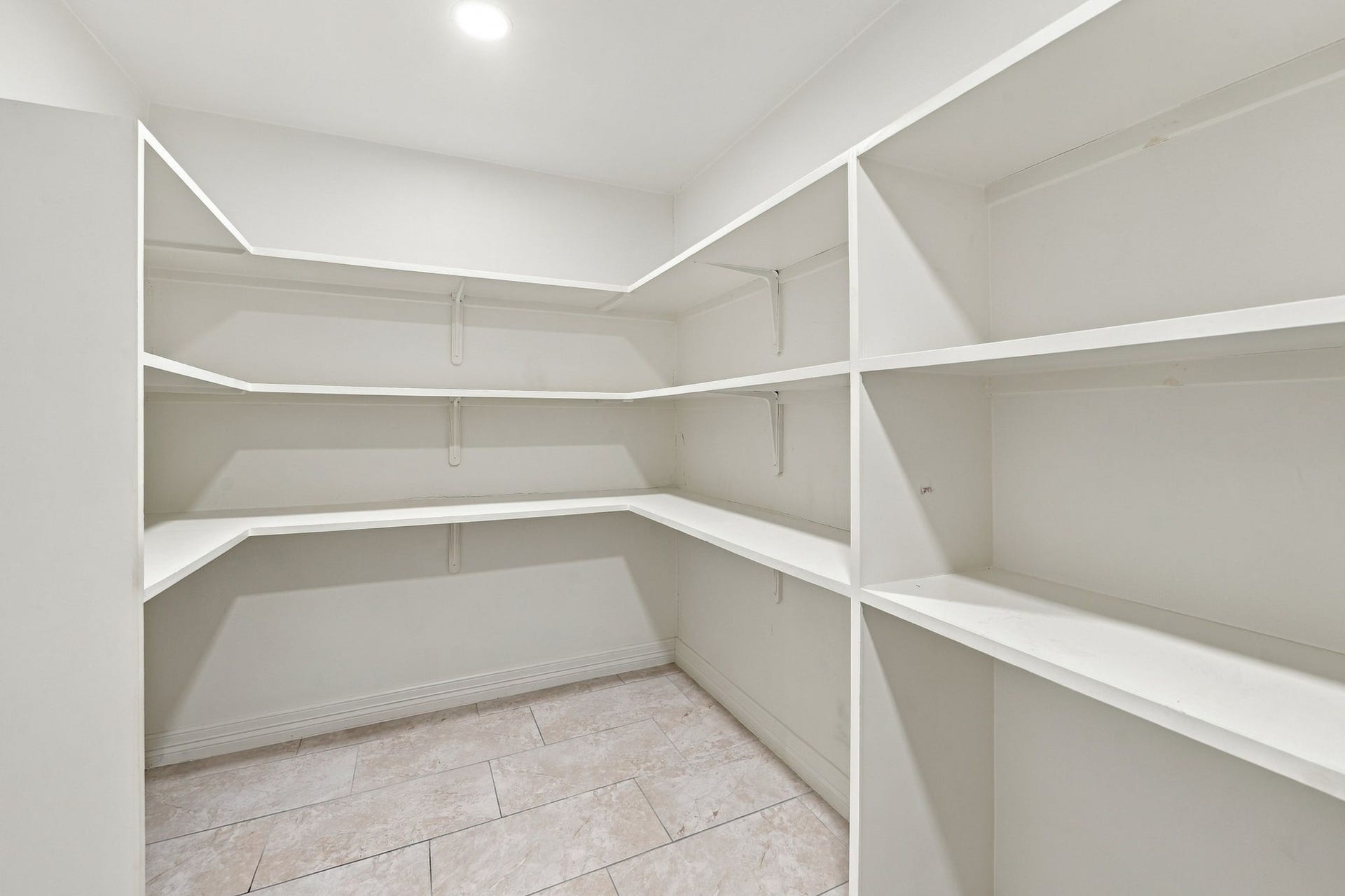 7610 Northwoods Drive, Sugar Land, TX 77479 Wraparound shelving makes excellent use of this walk-in closet, adding the kind of organized storage that makes everyday living easier.