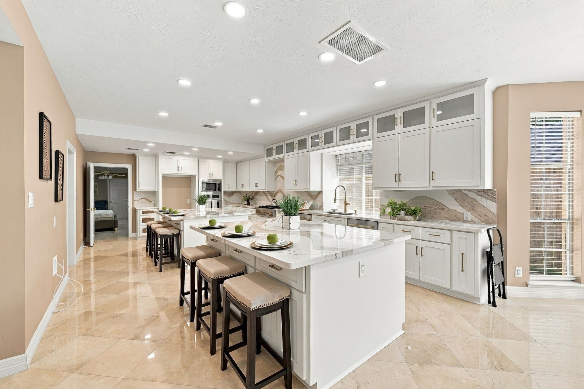 7610 Northwoods Drive, Sugar Land, TX 77479 Imagine hosting heremultiple islands provide room for preparing, serving, and seating while extensive cabinetry keeps everything beautifully organized.