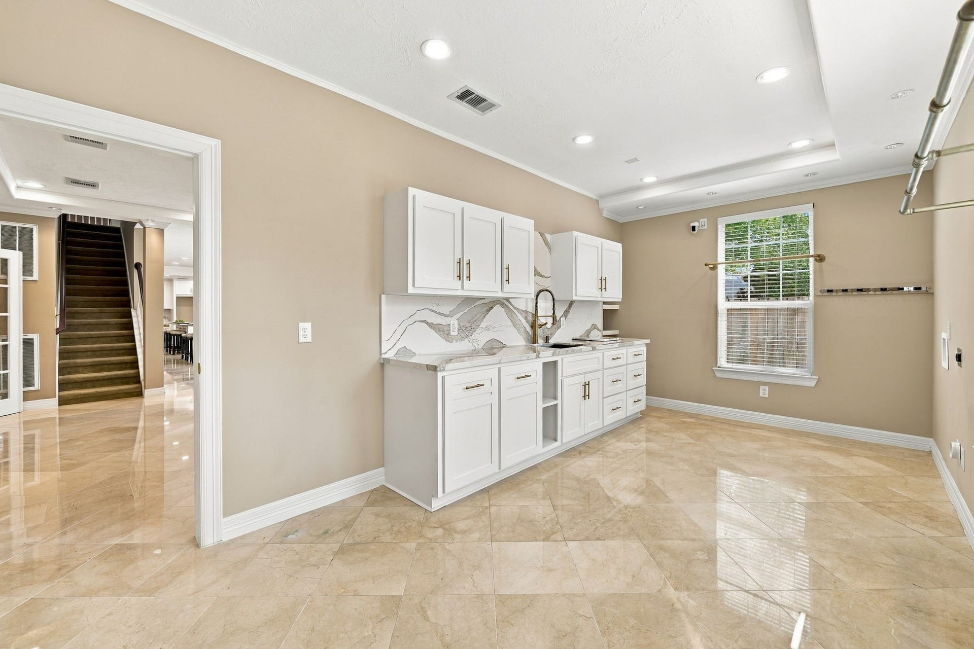 7610 Northwoods Drive, Sugar Land, TX 77479 Laundry feels far less like a chore in this dedicated utility room, offering abundant storage, a long work surface, and plenty of space to sort, fold, and organize.