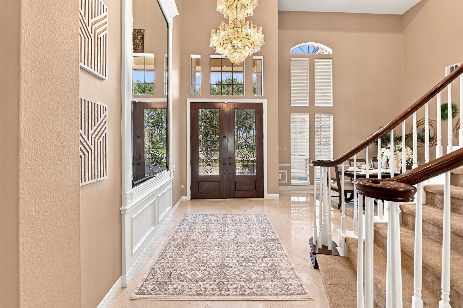 7610 Northwoods Drive, Sugar Land, TX 77479 Step inside to an impressive two-story foyer where tall windows, graceful architectural details and a sweeping staircase create a striking welcome.