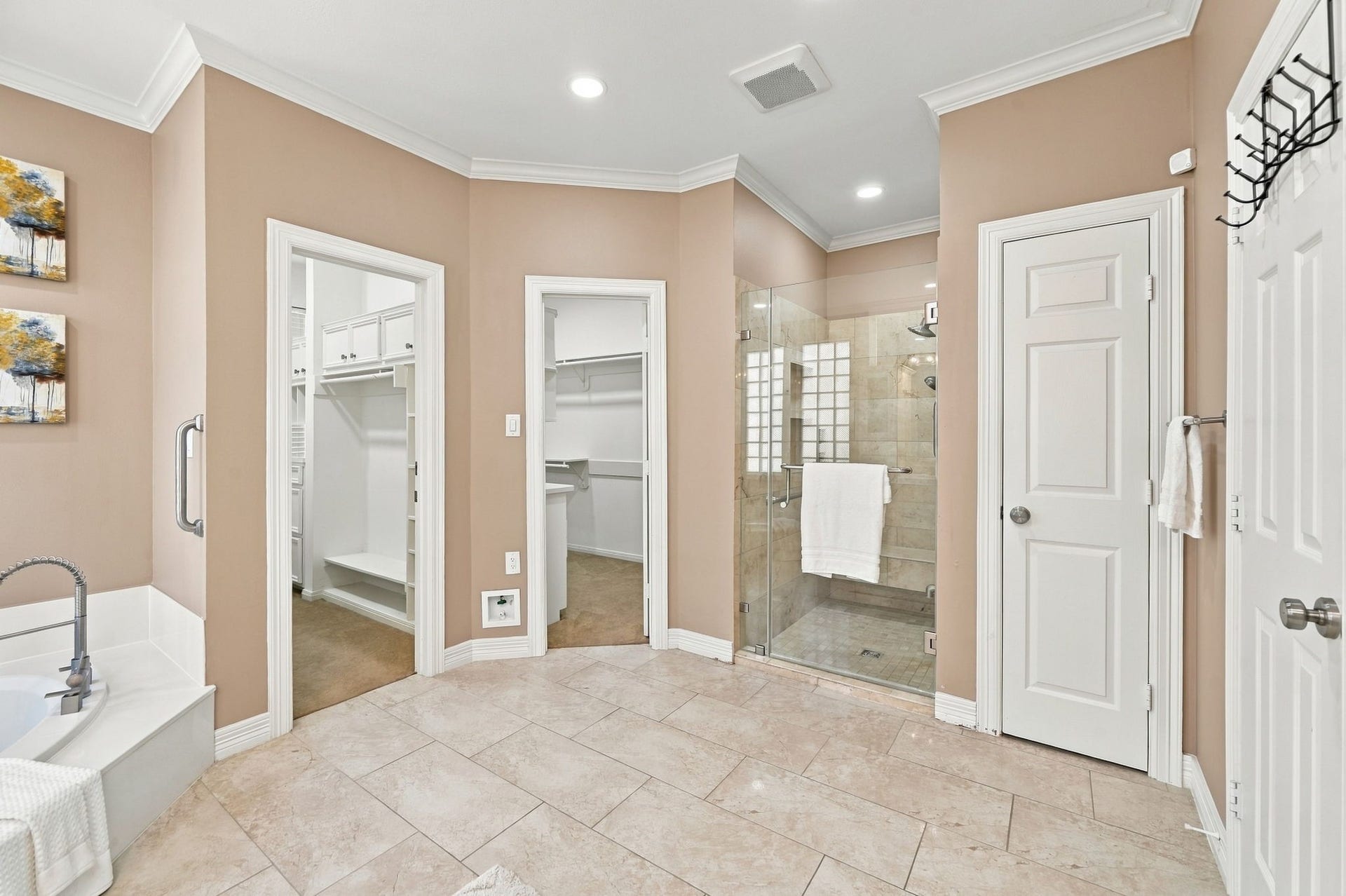 7610 Northwoods Drive, Sugar Land, TX 77479 Two separate closets and a walk-in shower elevate this primary bath with the kind of practical luxury that makes daily routines easier.