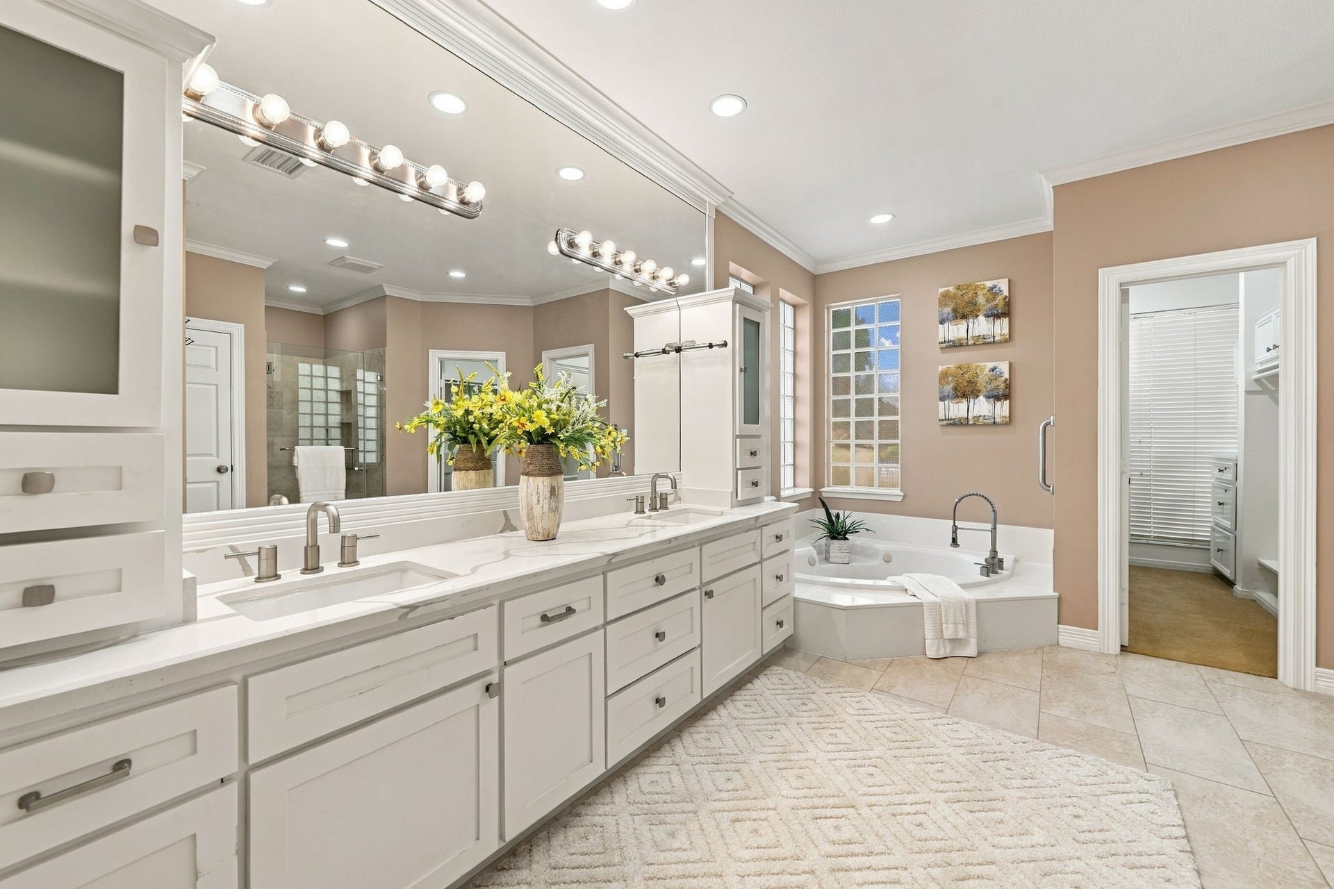 7610 Northwoods Drive, Sugar Land, TX 77479 Start and end your day in a primary bath designed for indulgence, pairing exceptional counter space with a dedicated soaking tub and direct closet access.