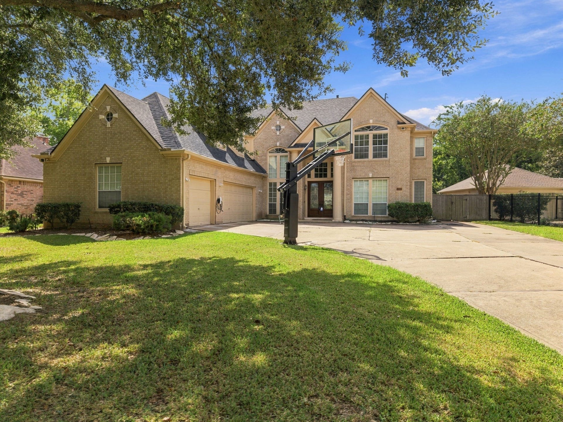 7610 Northwoods Drive, Sugar Land, TX 77479 Classic brick architecture and a commanding two-story faade give this home timeless curb appeal from the moment you arrive.