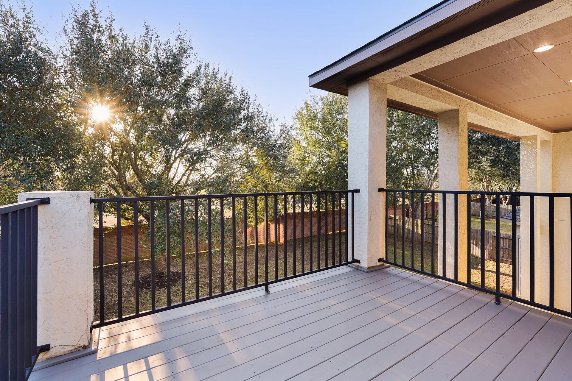 3102 Barrons Way, Sugar Land, TX 77479 Large balcony off Game Room with modern railing, offering scenic views of a tree-lined backyard. Perfect for relaxing and enjoying the outdoors.
