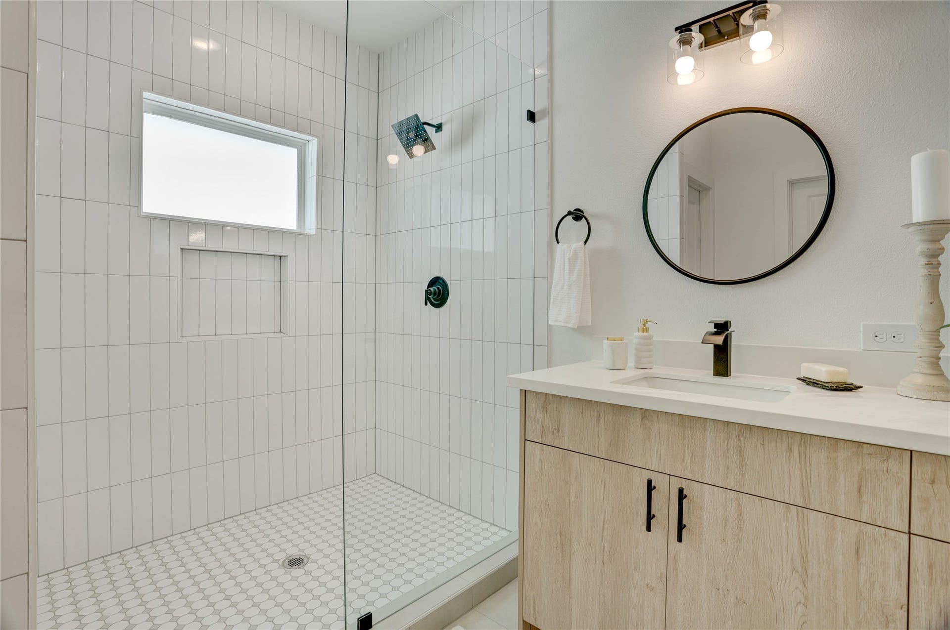 9610 Burden Street, Houston, TX 77093 The primary bath has a frameless standing shower with subway tile surround.