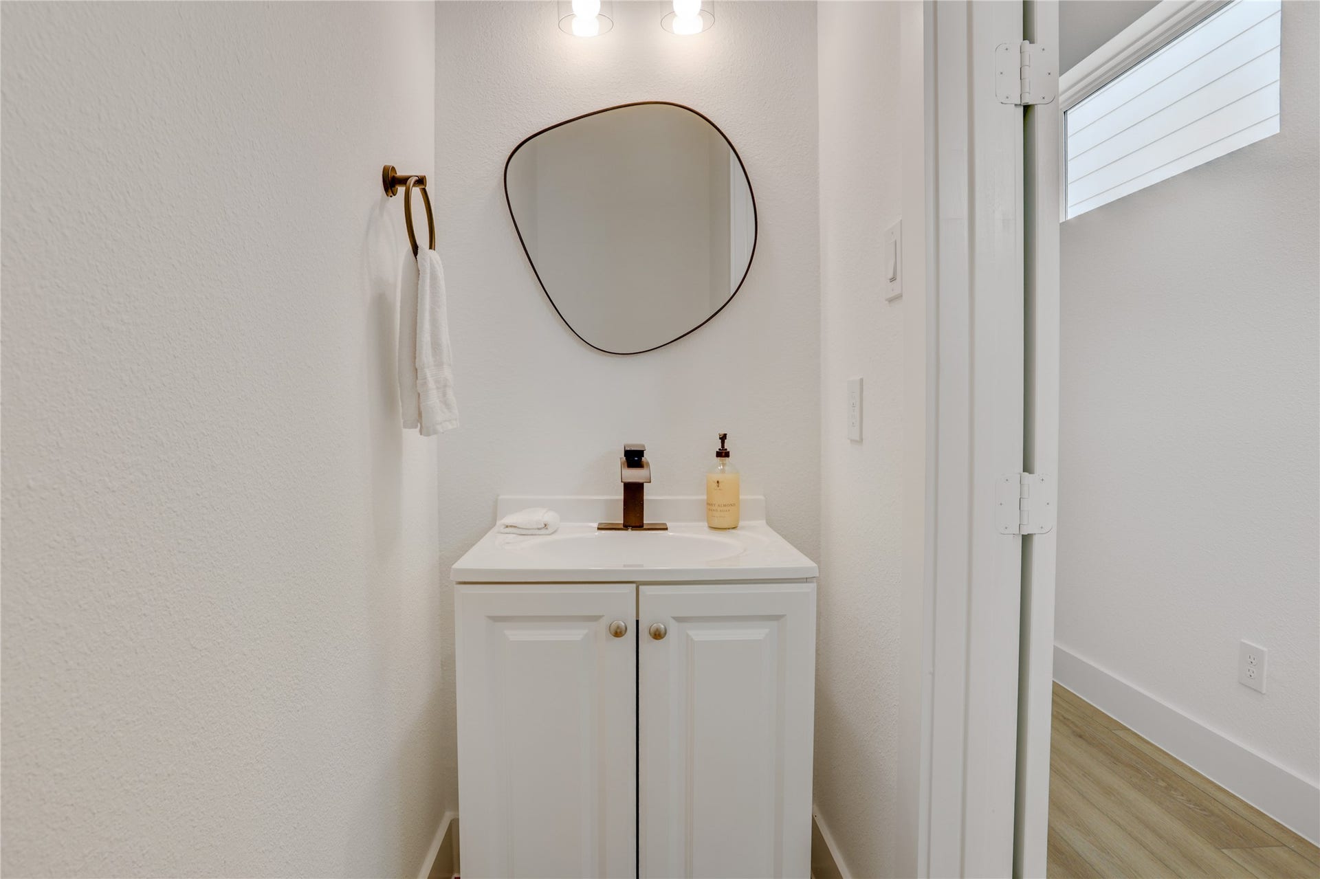 9610 Burden Street, Houston, TX 77093 The half-bath is in the entry hallway, away from the living areas, and has contemporary solid-wood cabinets and custom fixtures.