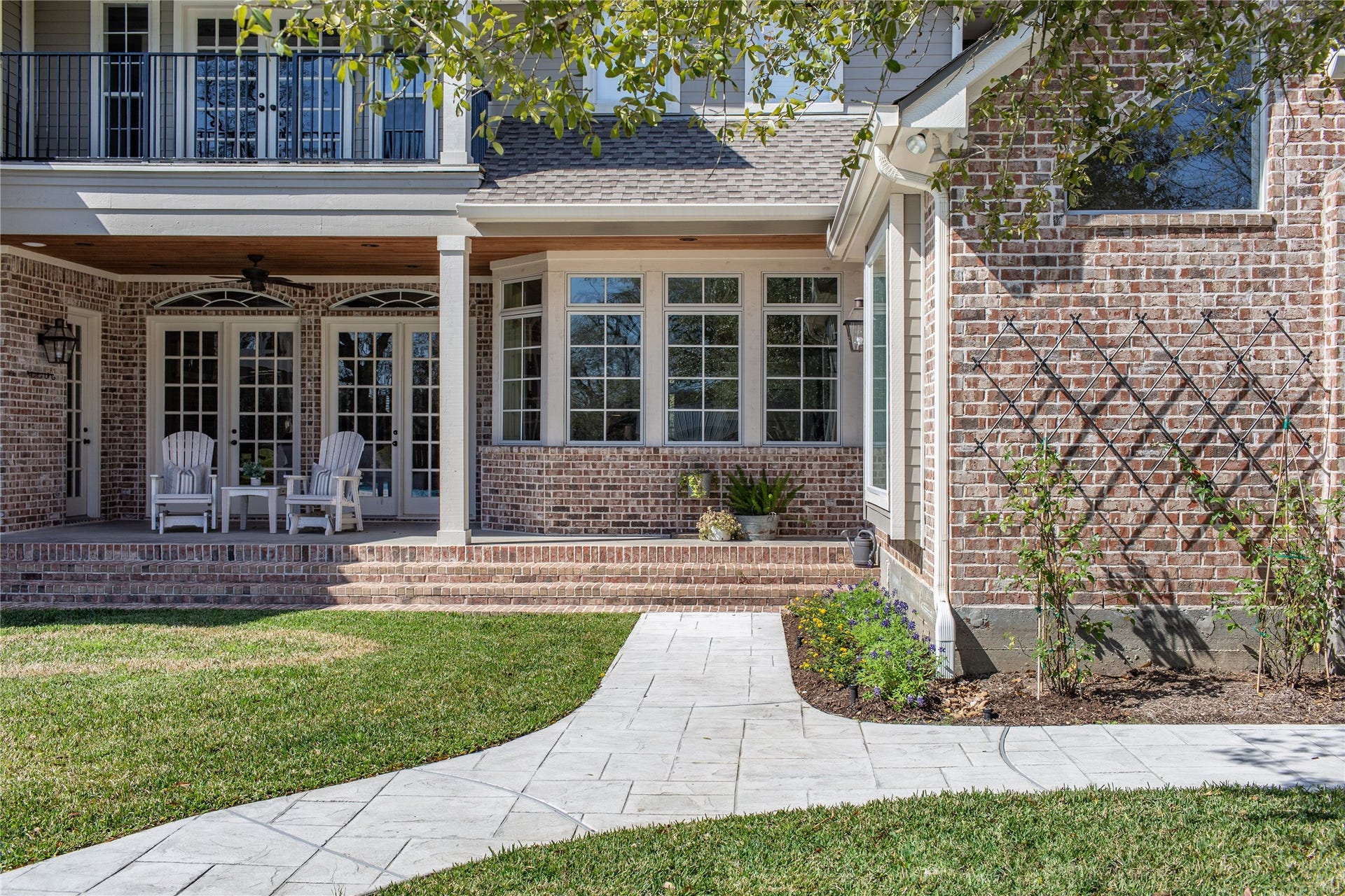 21110 Frey Lane, Tomball, TX 77377 Lesh landscaping meets cozy comfort on this dreamy back porch, the perfect spot for your morning coffee.