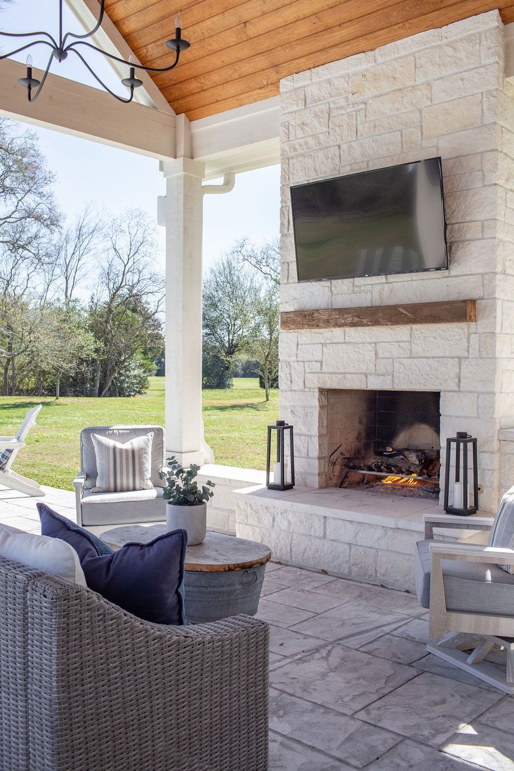 21110 Frey Lane, Tomball, TX 77377 Cozy fireplace, surround sound speakers, and a chandelier, all outside on the patio, which is great for all your entertaining needs