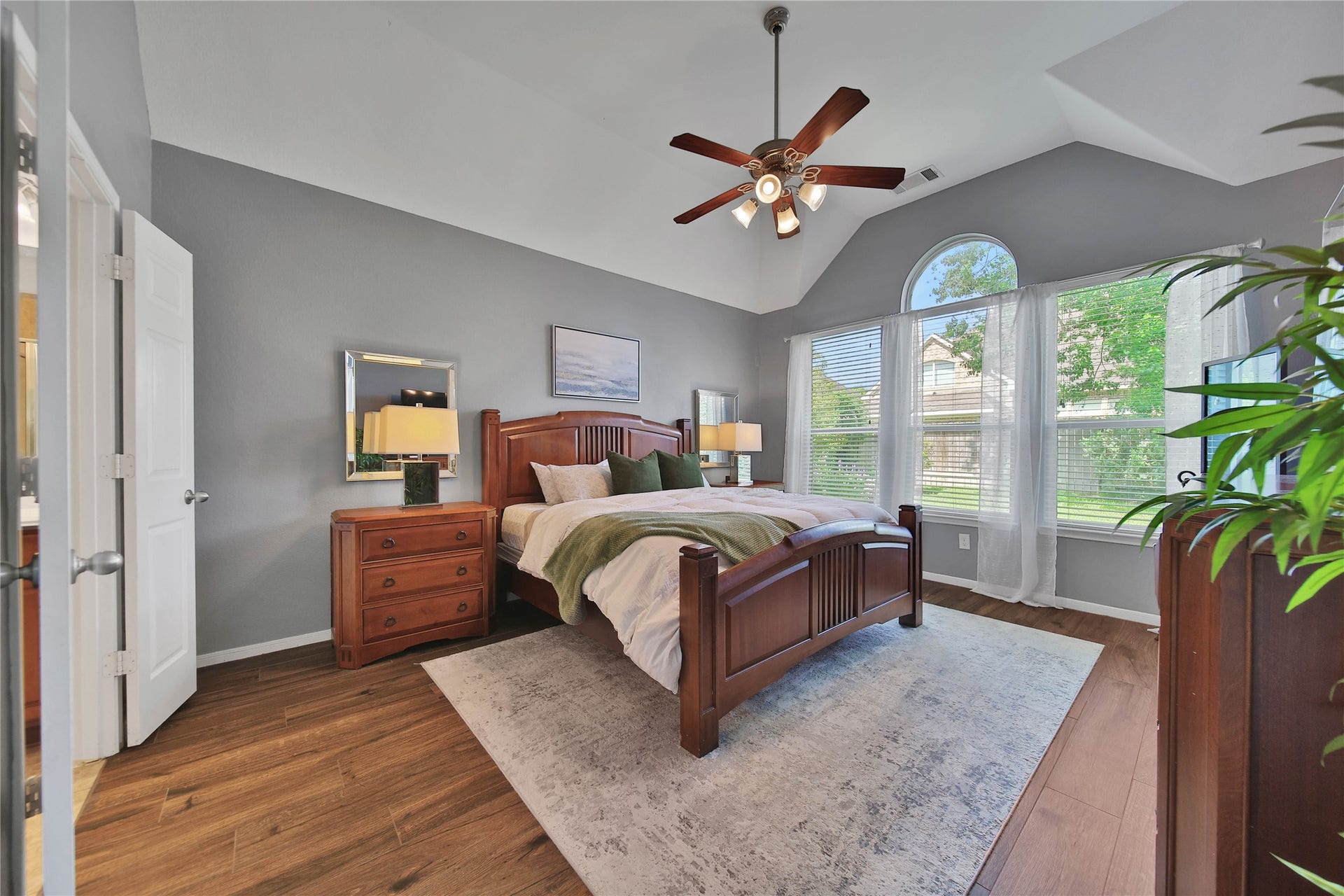 17311 Lassen Forest Lane, Humble, TX 77346 The primary bedroom is located downstairs and features high ceilings, bright views of the backyard and a spacious feel. The wood tile floors add durability and beauty.