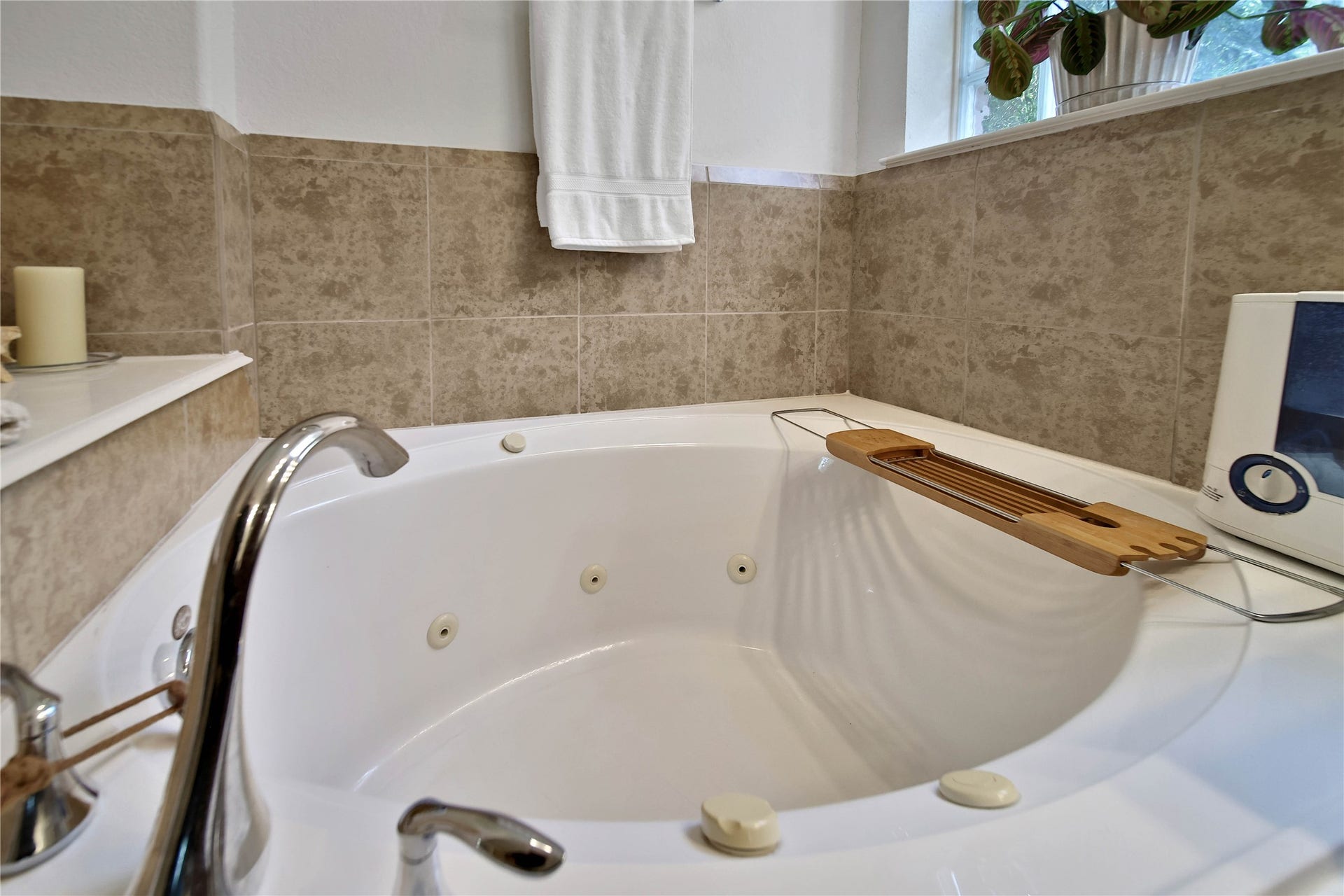 17311 Lassen Forest Lane, Humble, TX 77346 Natural light from the glass block window pours over the jetted tub soaker tub in en-suite bath.