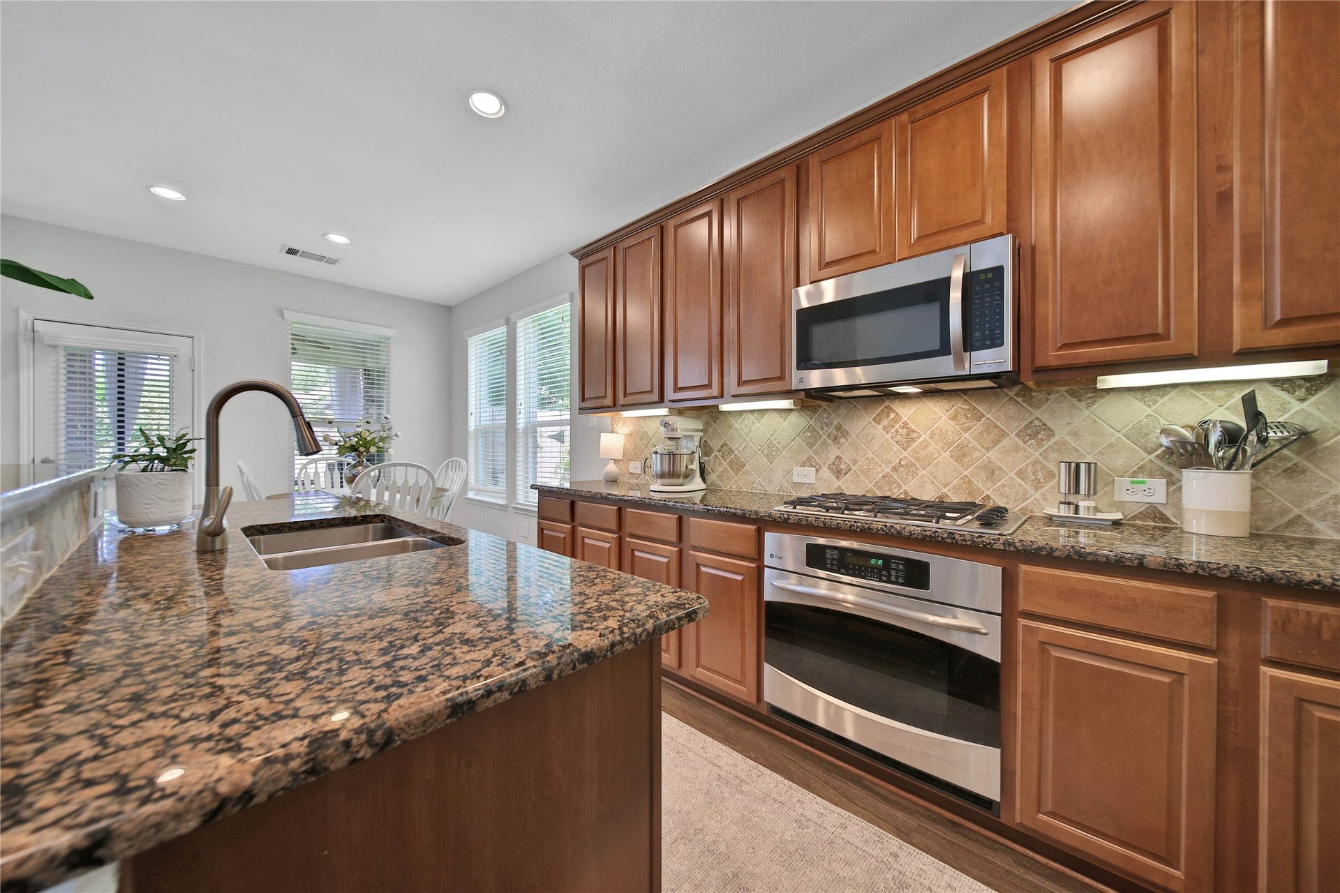17311 Lassen Forest Lane, Humble, TX 77346 Gas cooktop, over-range- microwave and built-in over elevate the kitchen.