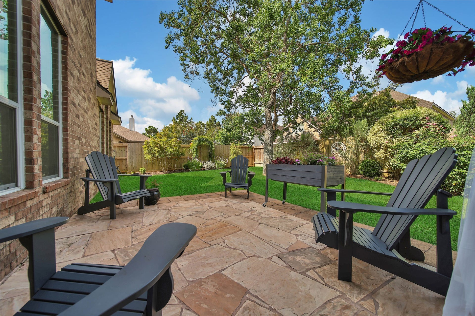 17311 Lassen Forest Lane, Humble, TX 77346 Enjoy this private backyard on the flagstone patio. Beautiful landscaping surrounds the backyard.