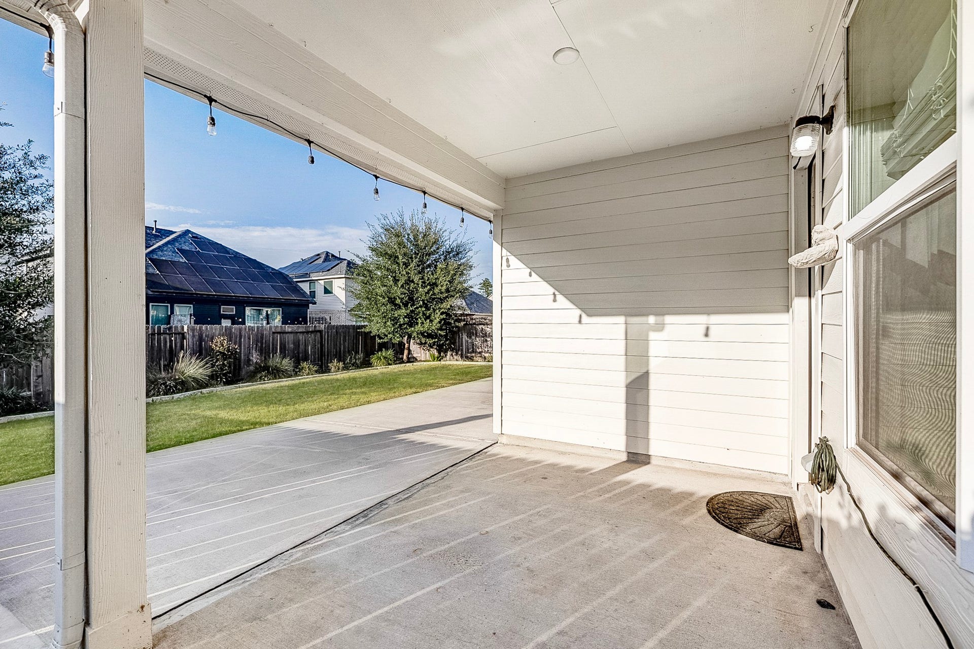 40638 Goldeneye Place, Magnolia, TX 77354 Charming covered patio with ample space, perfect for relaxing outdoors, overlooking a well-maintained backyard with lush grass and mature trees.