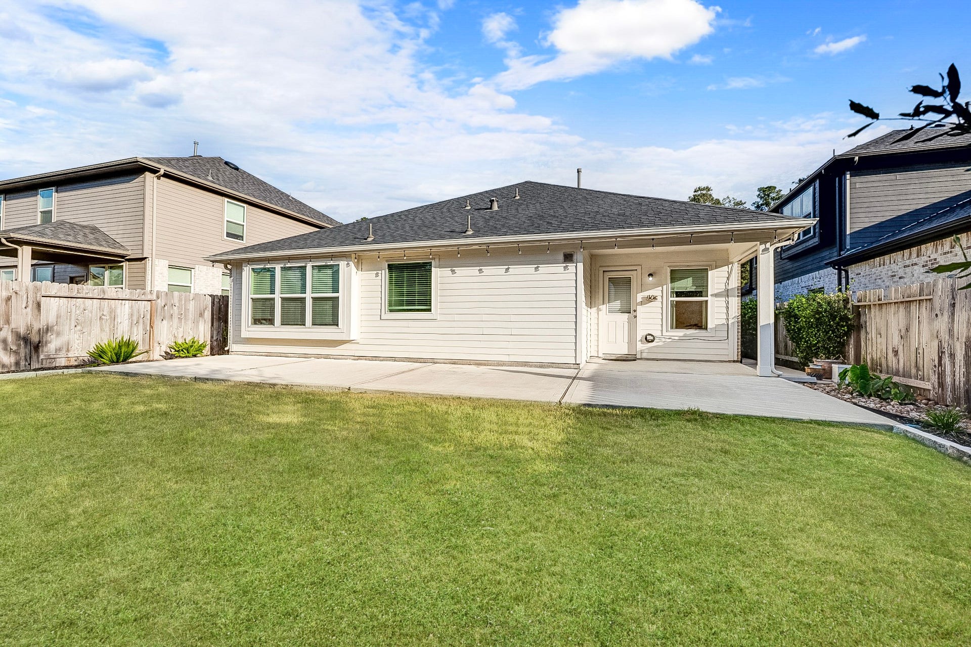 40638 Goldeneye Place, Magnolia, TX 77354 Charming single-story home features a spacious backyard with a well-maintained lawn and a covered patio area, perfect for outdoor gatherings.