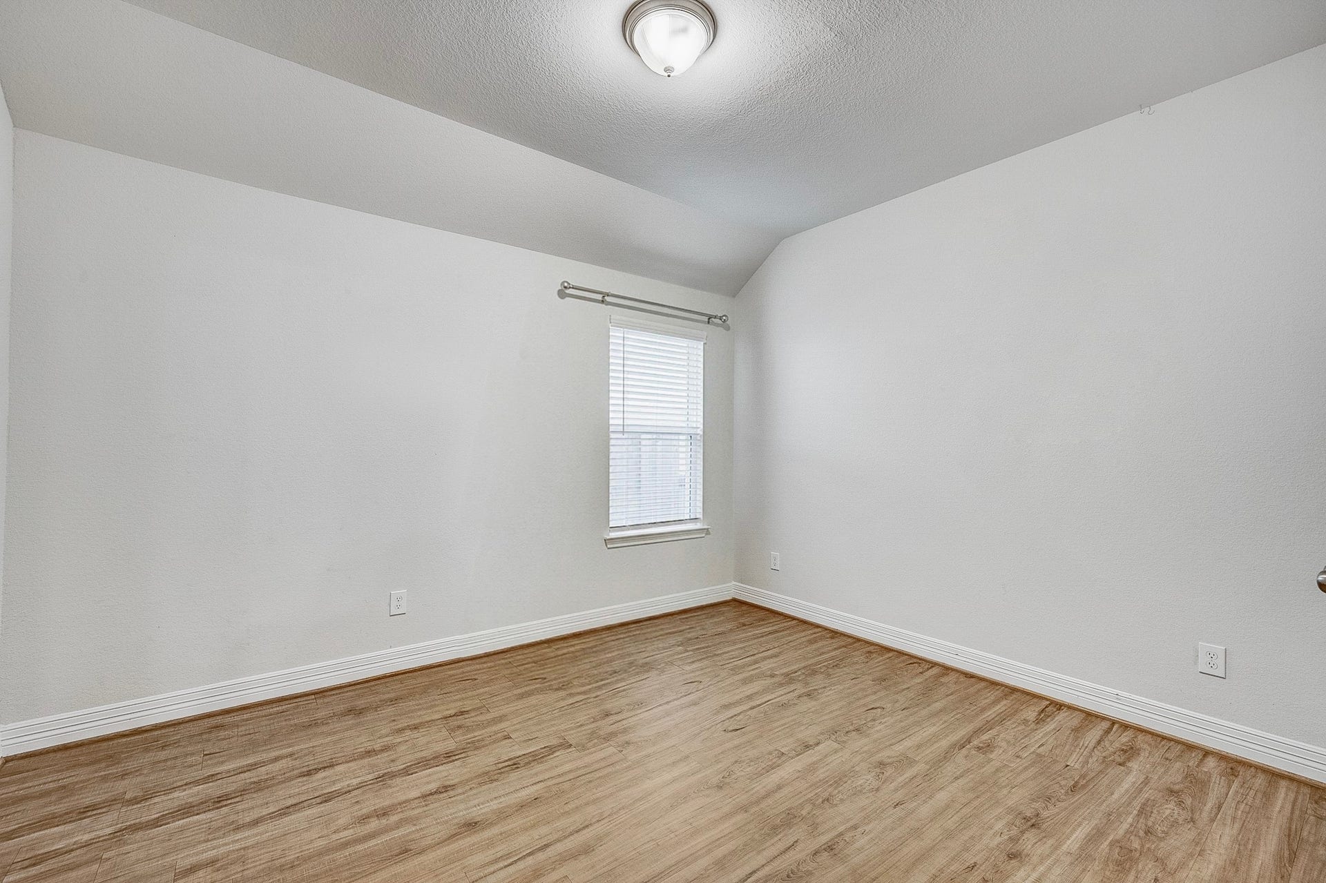 40638 Goldeneye Place, Magnolia, TX 77354 Bright and inviting room featuring sleek wood flooring, neutral walls, and a large window that fills the space with natural light.