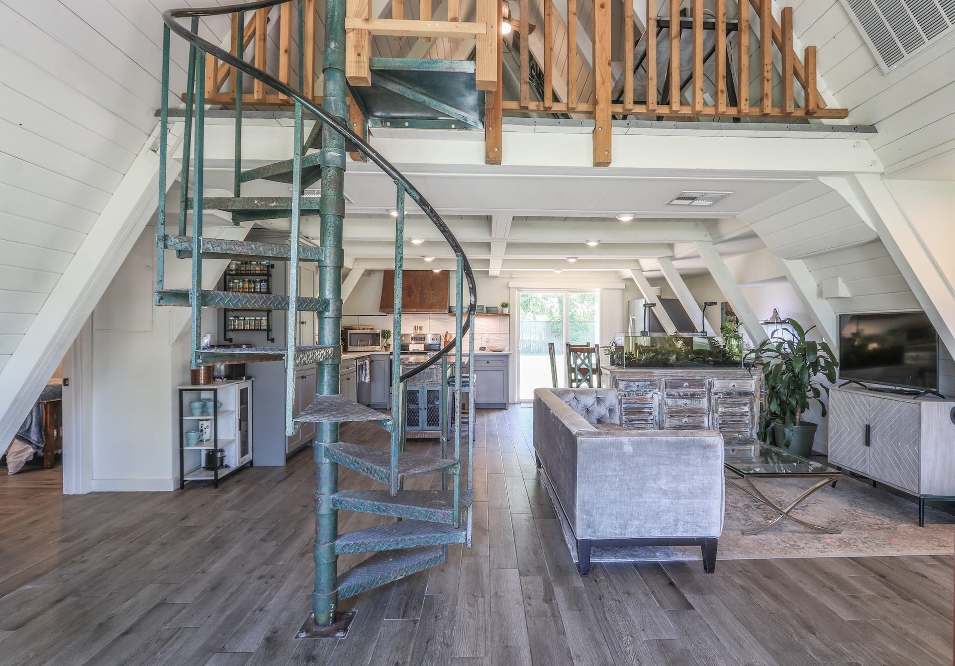 2575 Cliff Drive, Dickinson, TX 77539 Here is that 70's vibe with a spiral staircase that leads to a sizable loft and bonus room upstairs. The space up there could be used as an office, gameroom, guest suite with the bonus room off the open loft.