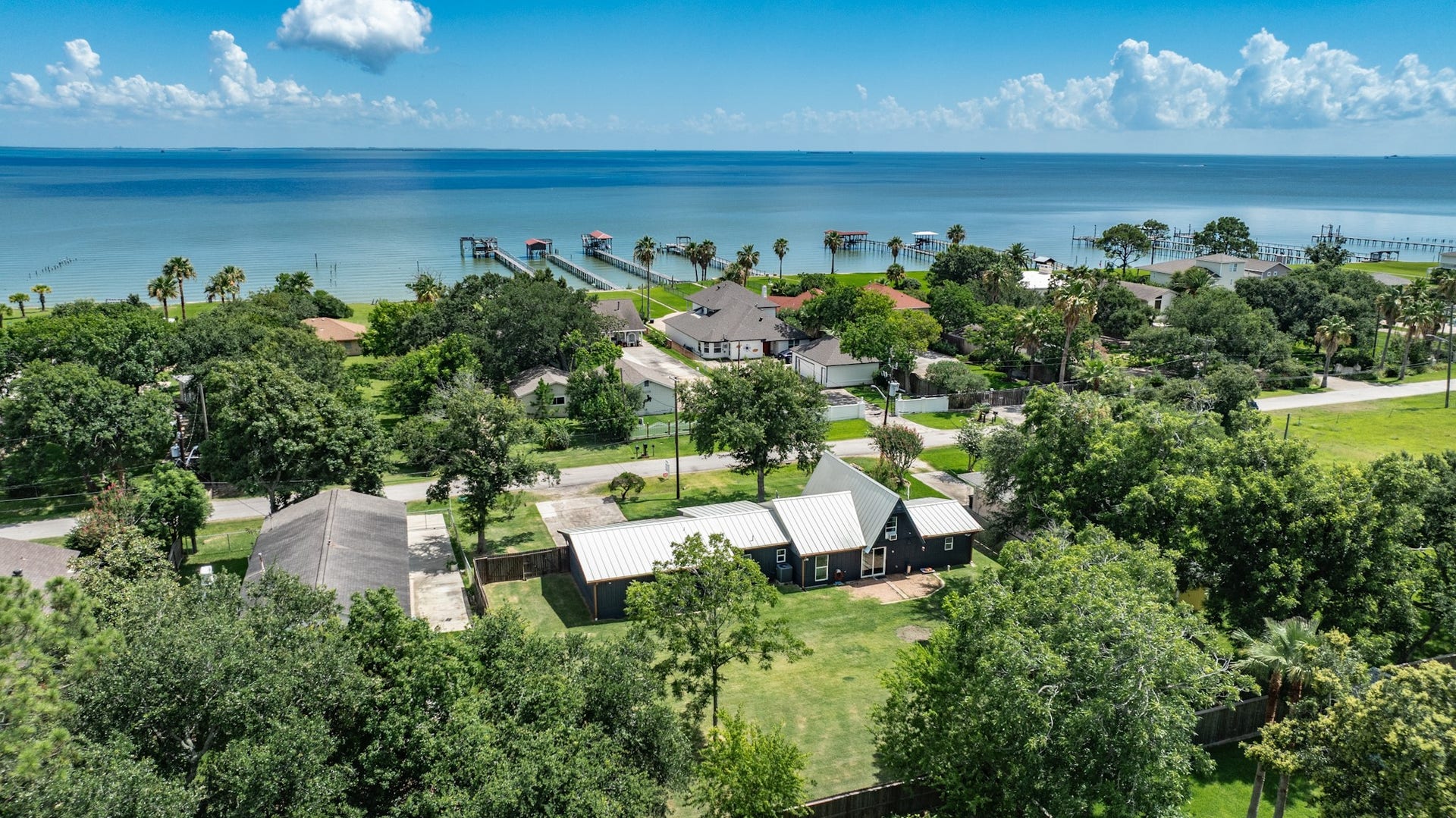 2575 Cliff Drive, Dickinson, TX 77539 This aeriel shot shows the back of the home and its proximity to the water! Easy to walk around the corner and drop a line in the water or just enjoy the view.