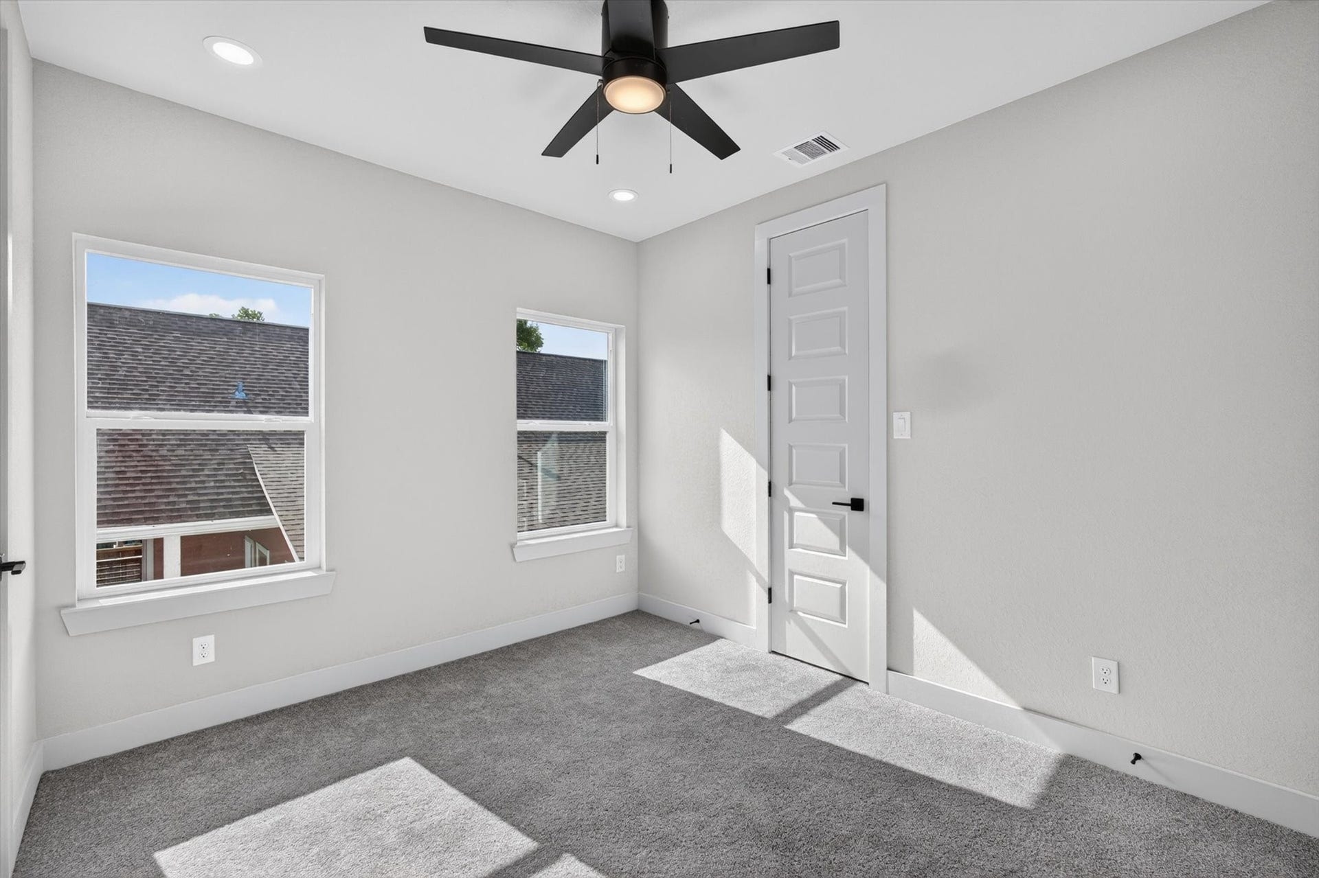 8027 BETTY BOOP Street, Houston, TX 77028 This photo features a modern, open-concept living and dining area with large windows, contemporary furnishings, and wood flooring. The space is bright and inviting, with neutral tones and stylish decor, making it ideal for entertaining or relaxing.