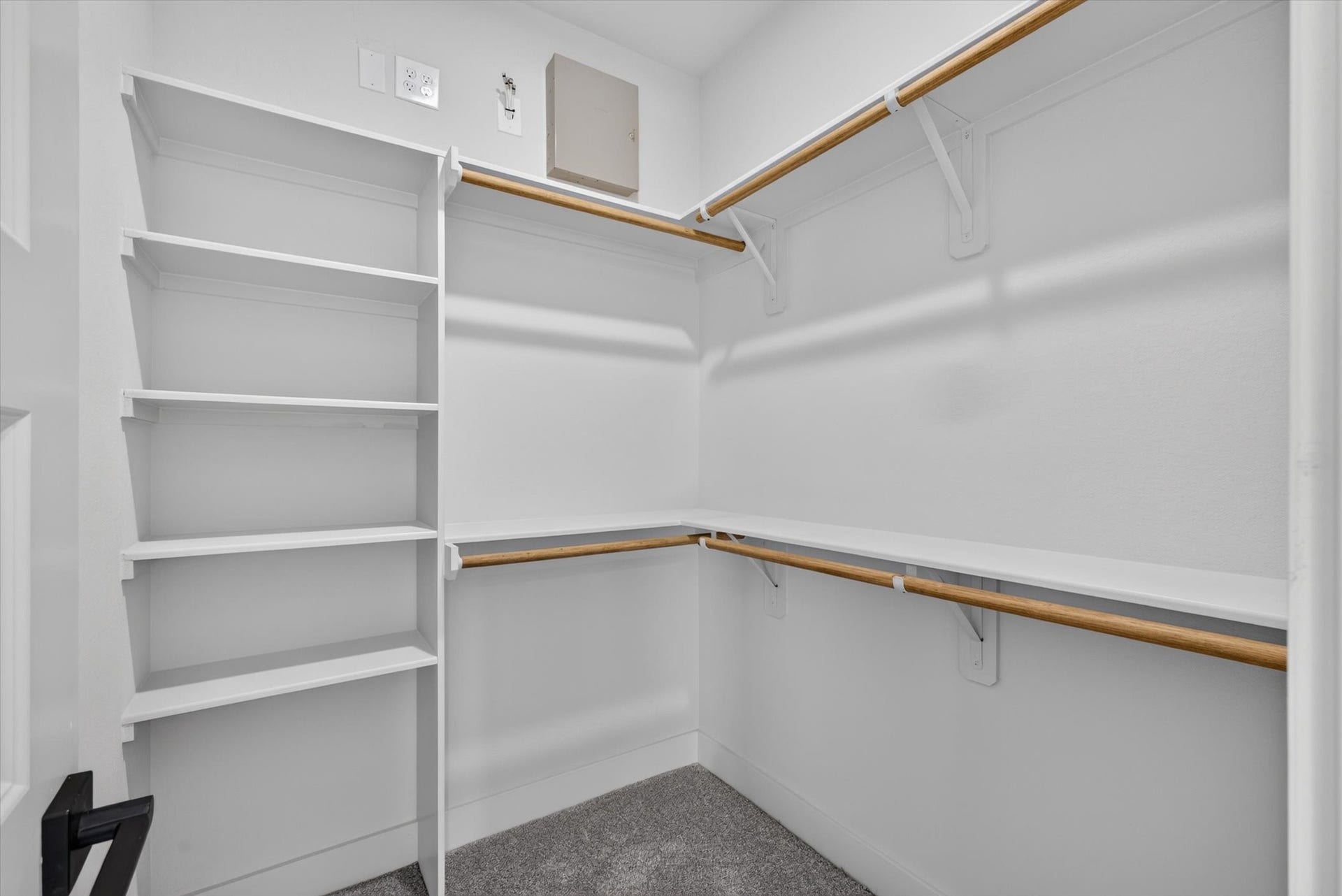 8027 BETTY BOOP Street, Houston, TX 77028 This photo shows a spacious walk-in closet with double hanging rods and built-in shelving, providing ample storage space. The neutral gray walls and white trim create a modern, clean look.