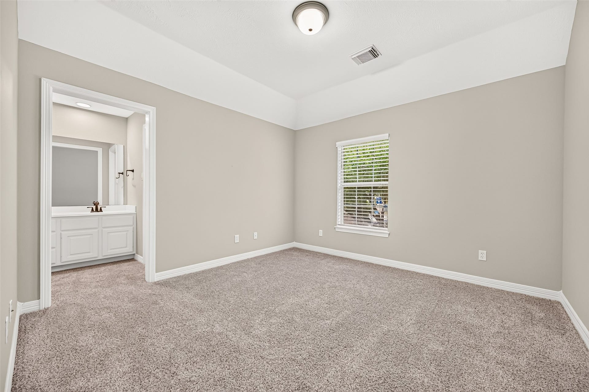 826 Ivory Ridge Lane, Houston, TX 77094 BEDROOM #2 offers a spacious layout with plenty of room for a complete bedroom suite. A large window brings in natural light, while the high ceiling adds to the open feel. Plush carpeting & fresh neutral paint create a clean backdrop ready for personal touches. Best of all, Bedroom #2 enjoys direct access to the Jack & Jill bath shared with Bedroom #3, providing added convenience & privacy.