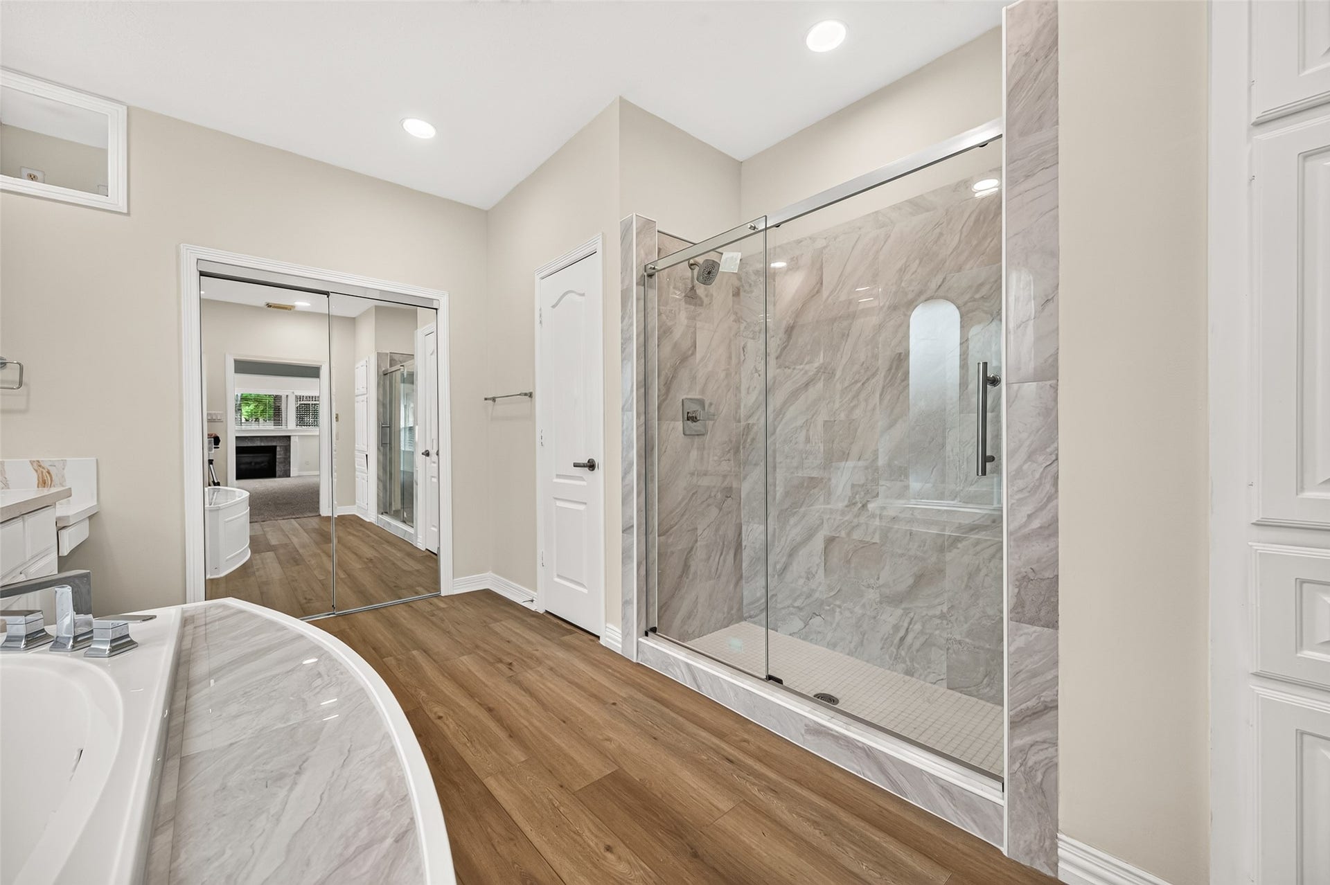 826 Ivory Ridge Lane, Houston, TX 77094 START THE DAY REFRESHED! Completely updated in 2026, the generously sized walk-in shower features floor-to-ceiling tile, a frameless glass enclosure, built-in bench & updated showerhead. Its spacious design provides plenty of elbow room, while the glass enclosure keeps the bath feeling open & bright. A private water closet keeps the commode discreetly tucked away, while mirrored closet doors lead to generous closet. Even the built-in cabinet offers a surprisea laundry chute directly to the Utility Room.