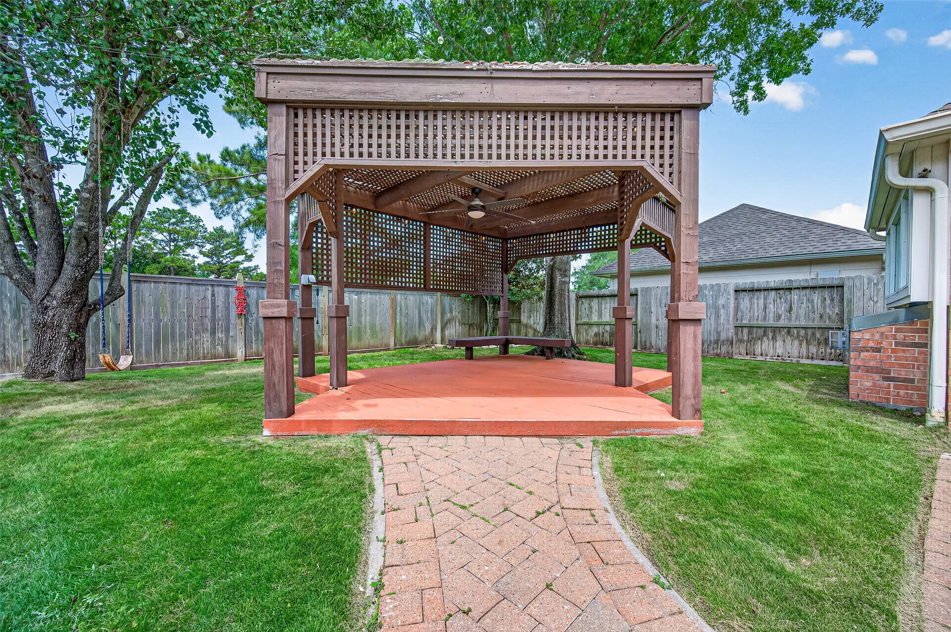 826 Ivory Ridge Lane, Houston, TX 77094 YOUR OWN BACKYARD GATHERING SPOT! Follow the paver walkway to the spacious backyard pergolaan inviting setting for outdoor dining, entertaining or simply unwinding at the end of the day. The substantial wood structure features latticework for filtered shade, a ceiling fan & built-in bench seating, with plenty of room to create your own outdoor living area beneath the mature trees.