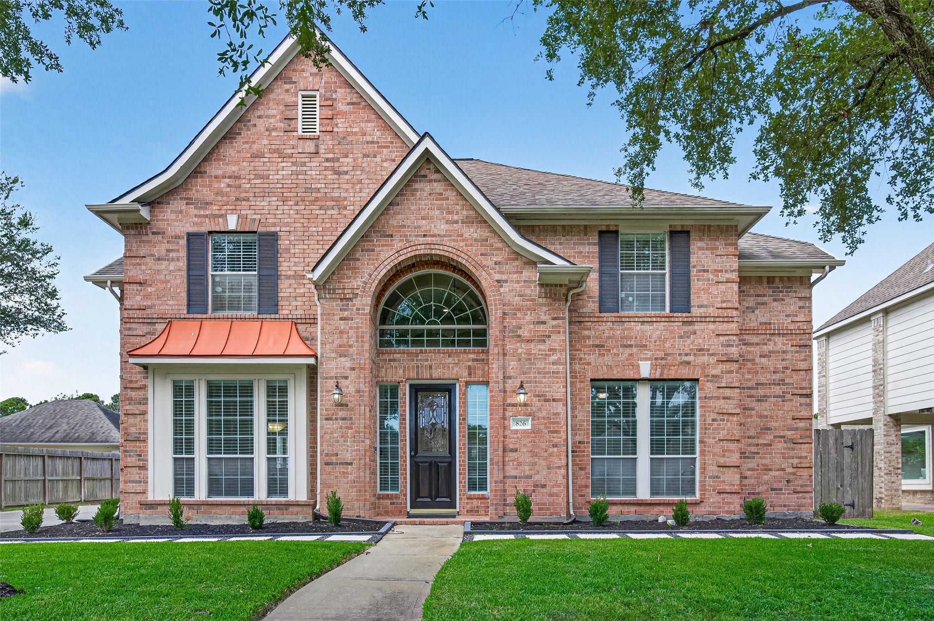 826 Ivory Ridge Lane, Houston, TX 77094 COME A LITTLE CLOSER... The dramatic arched COVERED ENTRY is not only a beautiful architectural feature, but provides welcome shelter from the elements for arriving guests & package deliveries. Brick-pavered entry, coach lights, Ring doorbell, & refinished leaded-glass front door (2026) create a warm welcome. Full sprinkler system in the front & back yards helps keep the lawn & landscaping green and healthy year-round. Now, lets step inside!